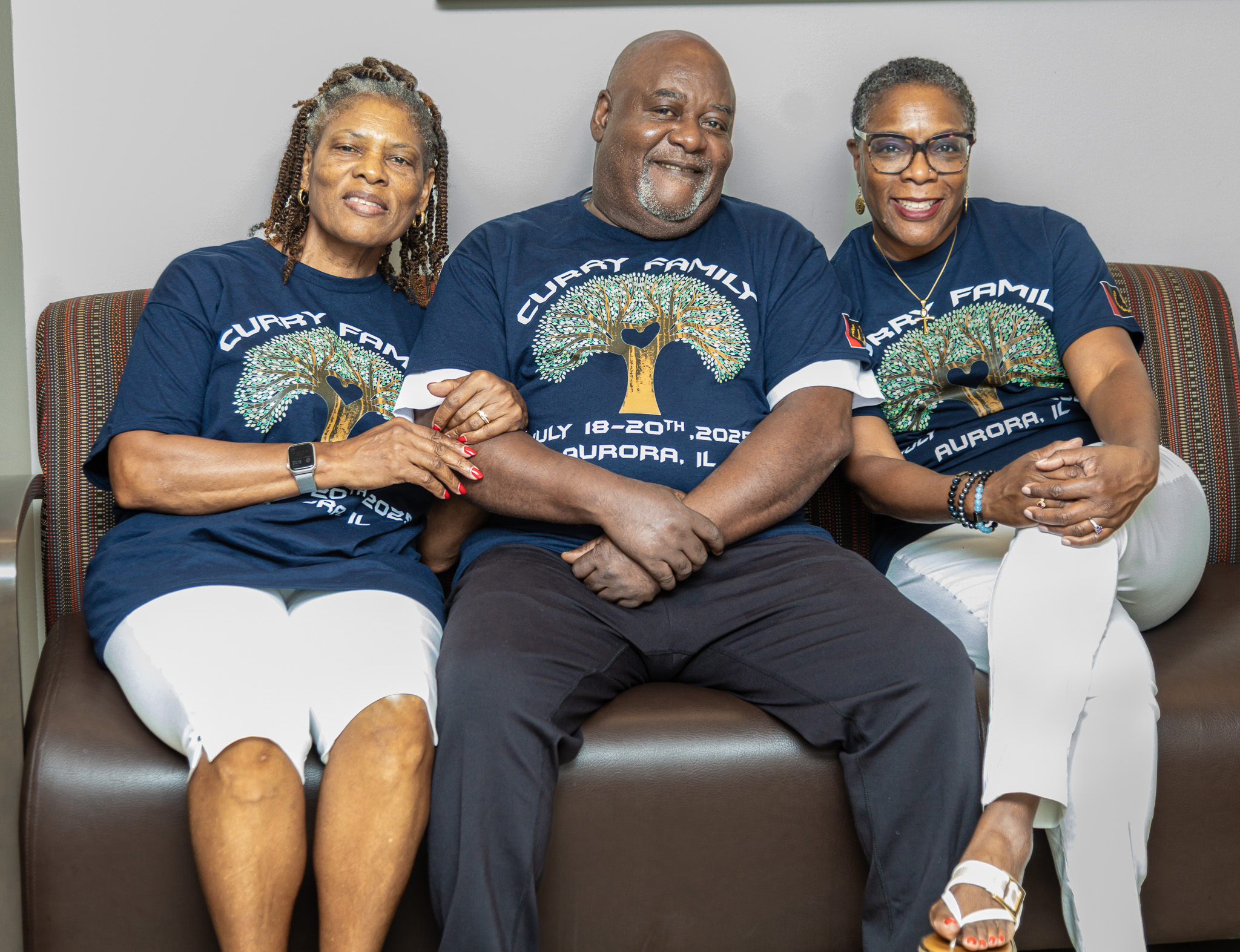 Curry family members seated together in reunion shirts