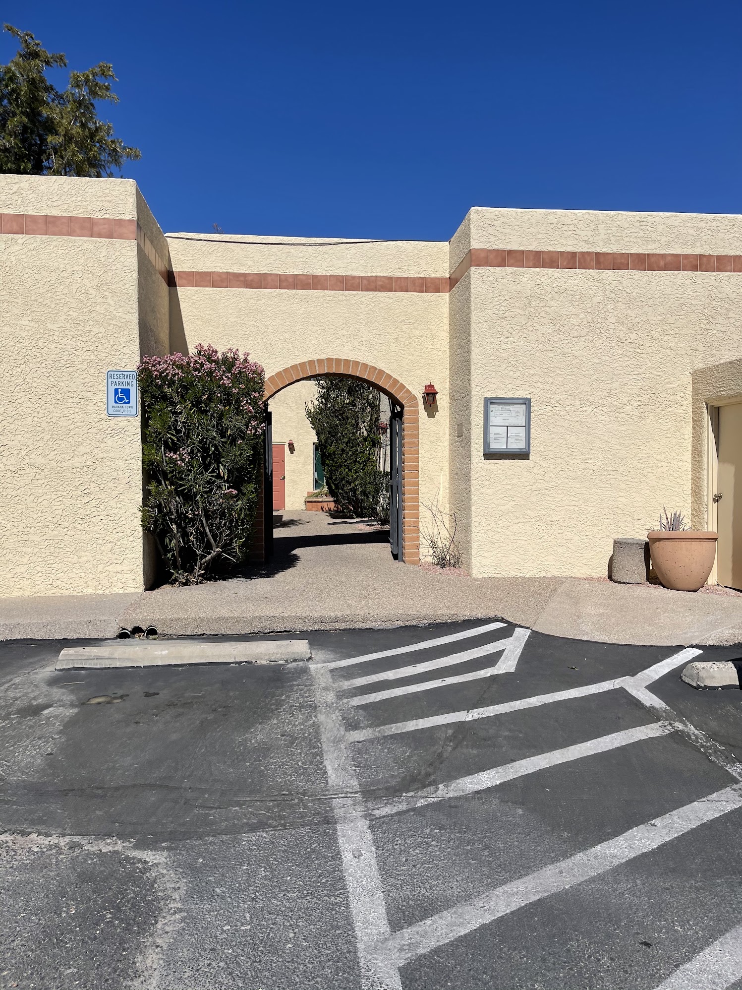 Building entrance archway and accessible parking leading to Suite #149