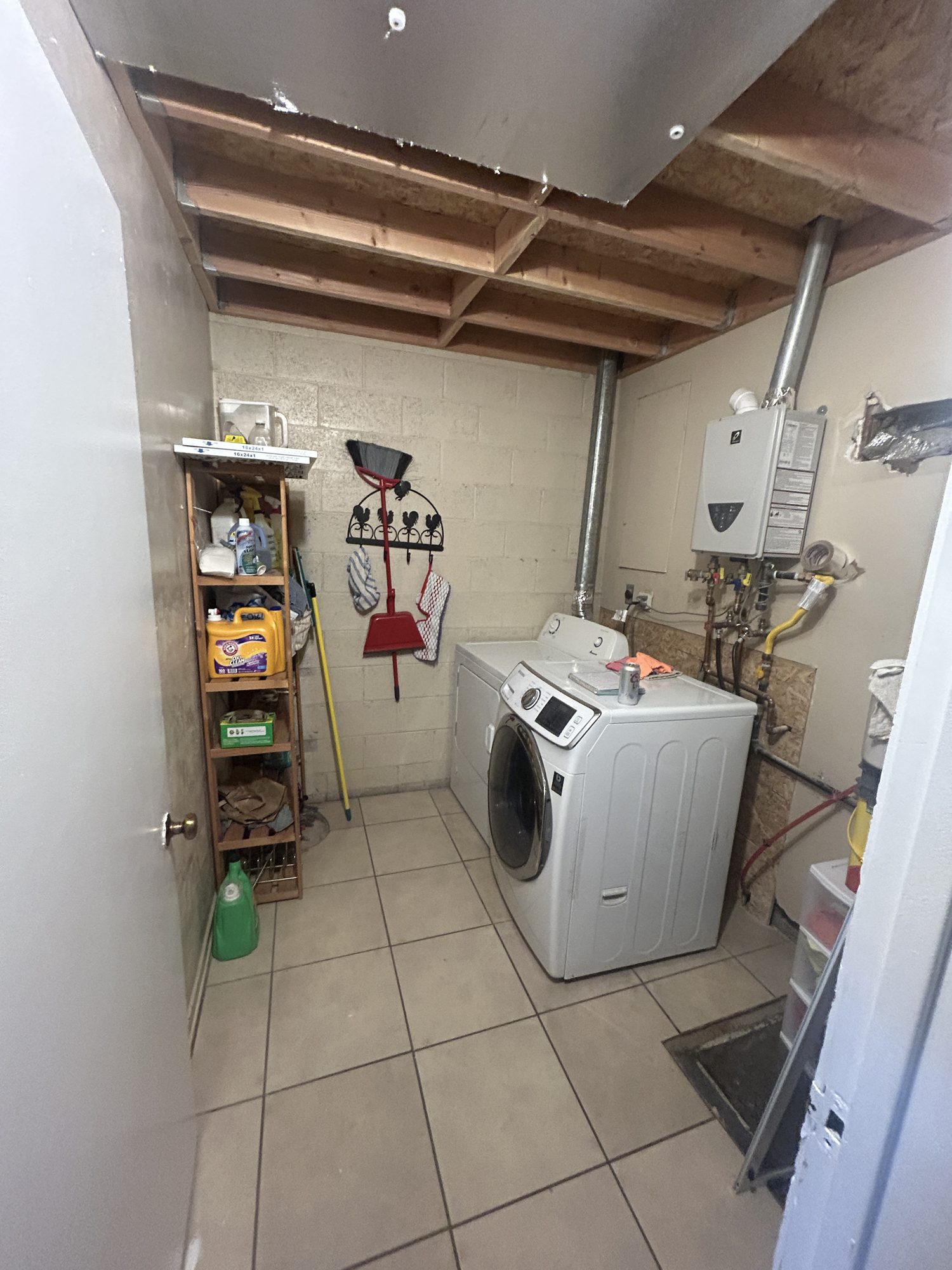 Original utility laundry room with exposed ceiling joists before remodel, Reno, NV