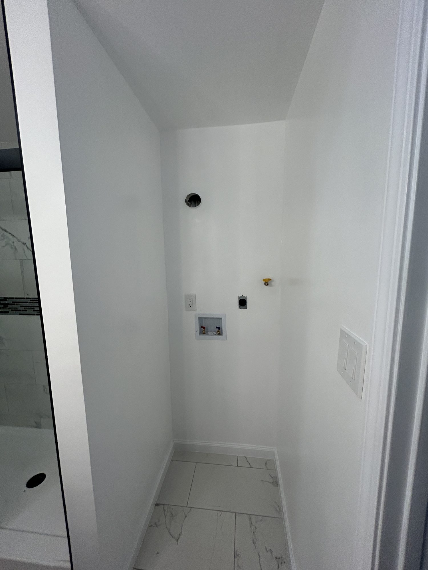 Finished laundry nook with washer dryer hookups and porcelain tile floor, Reno, NV