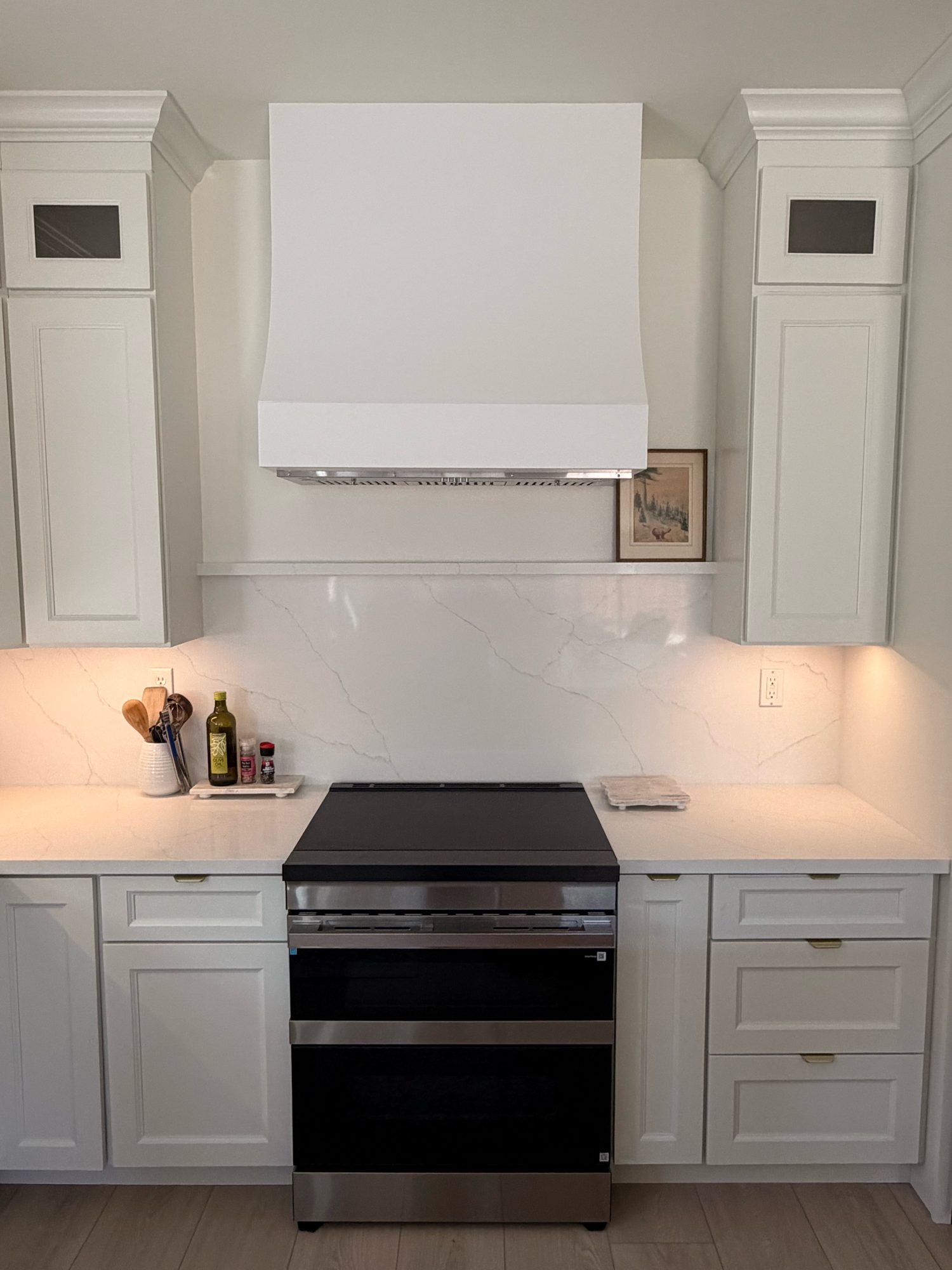 Full-height quartz slab backsplash and custom range hood, Reno, NV
