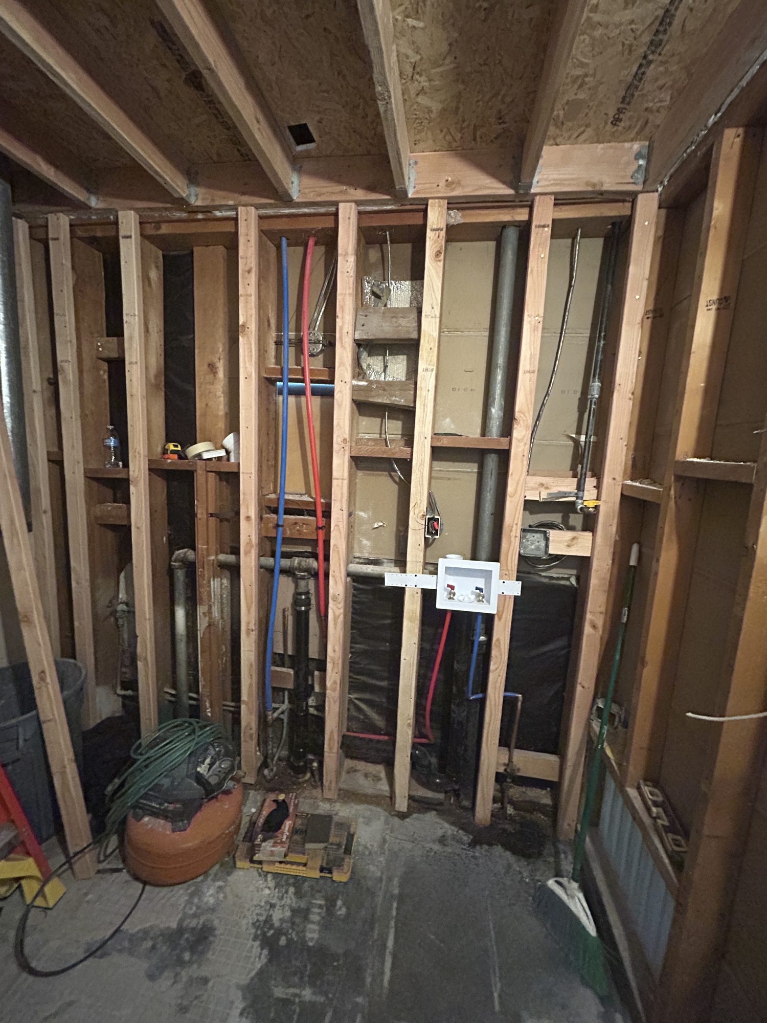 Bare stud framing, PEX lines, vent stacks, and rough plumbing before drywall, Reno, NV
