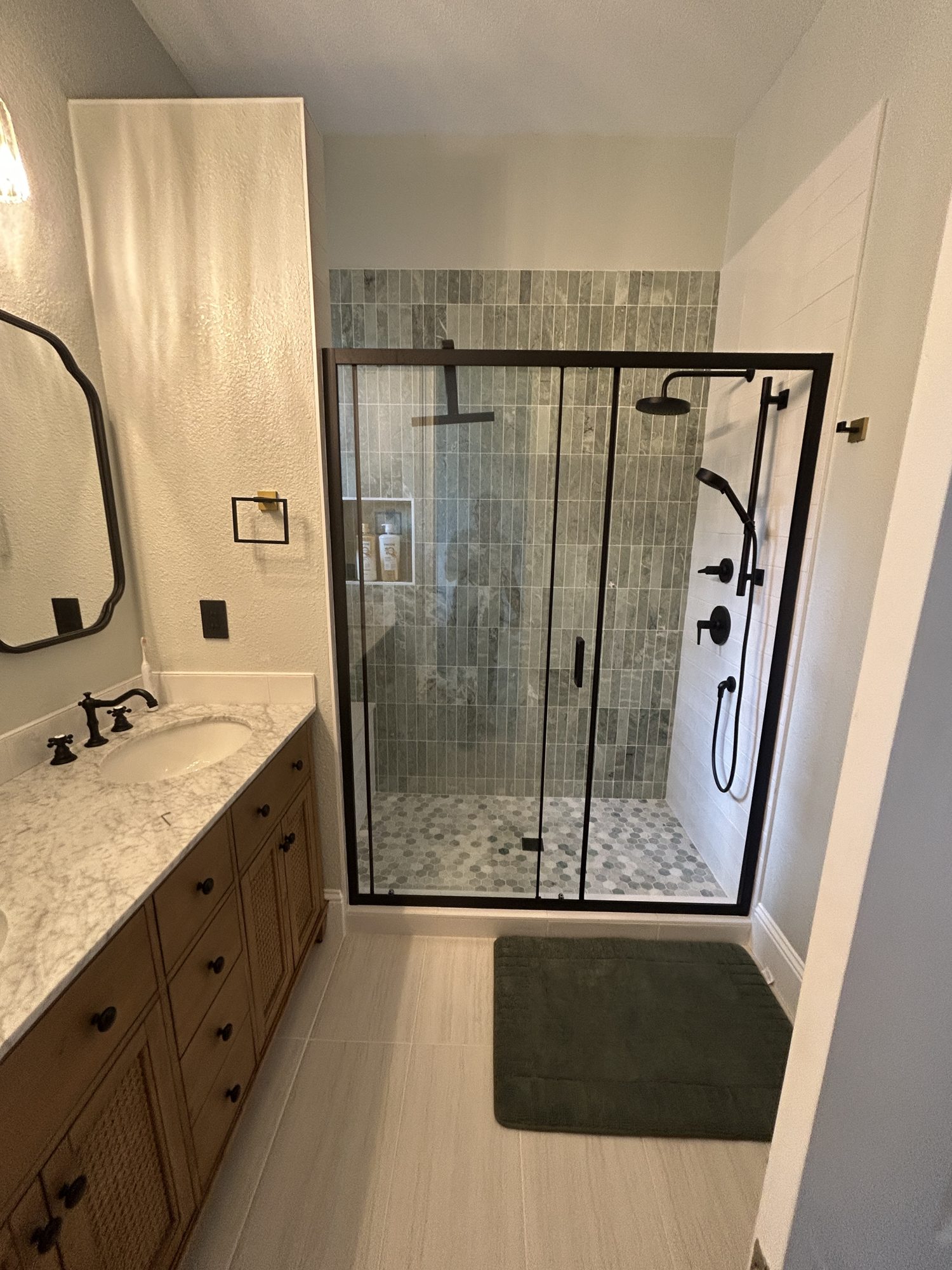 Bathroom vanity and glass shower enclosure with large-format floor tile, Reno, NV