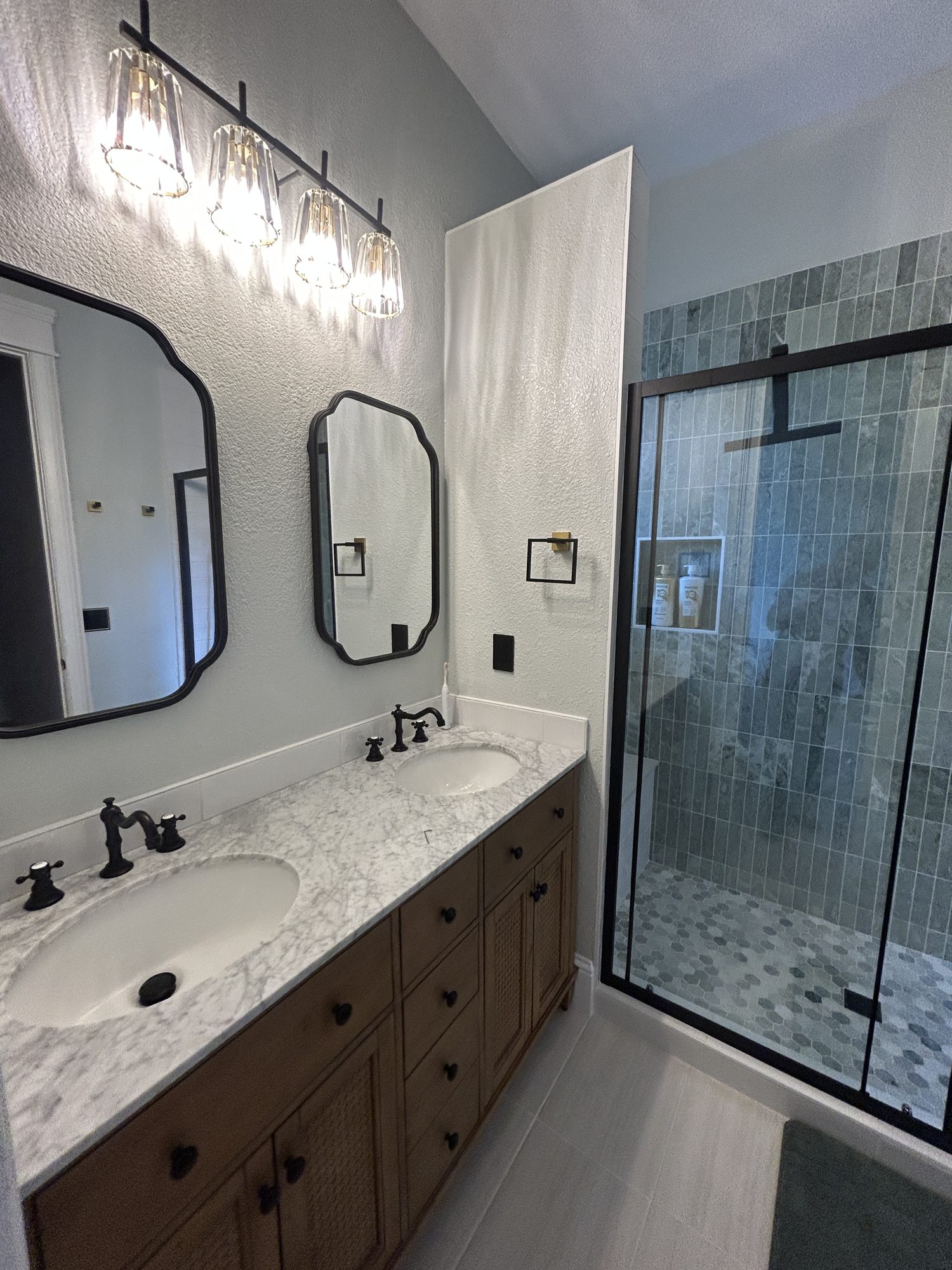 Marble double vanity countertop with undermount sinks and black fixtures, Reno, NV
