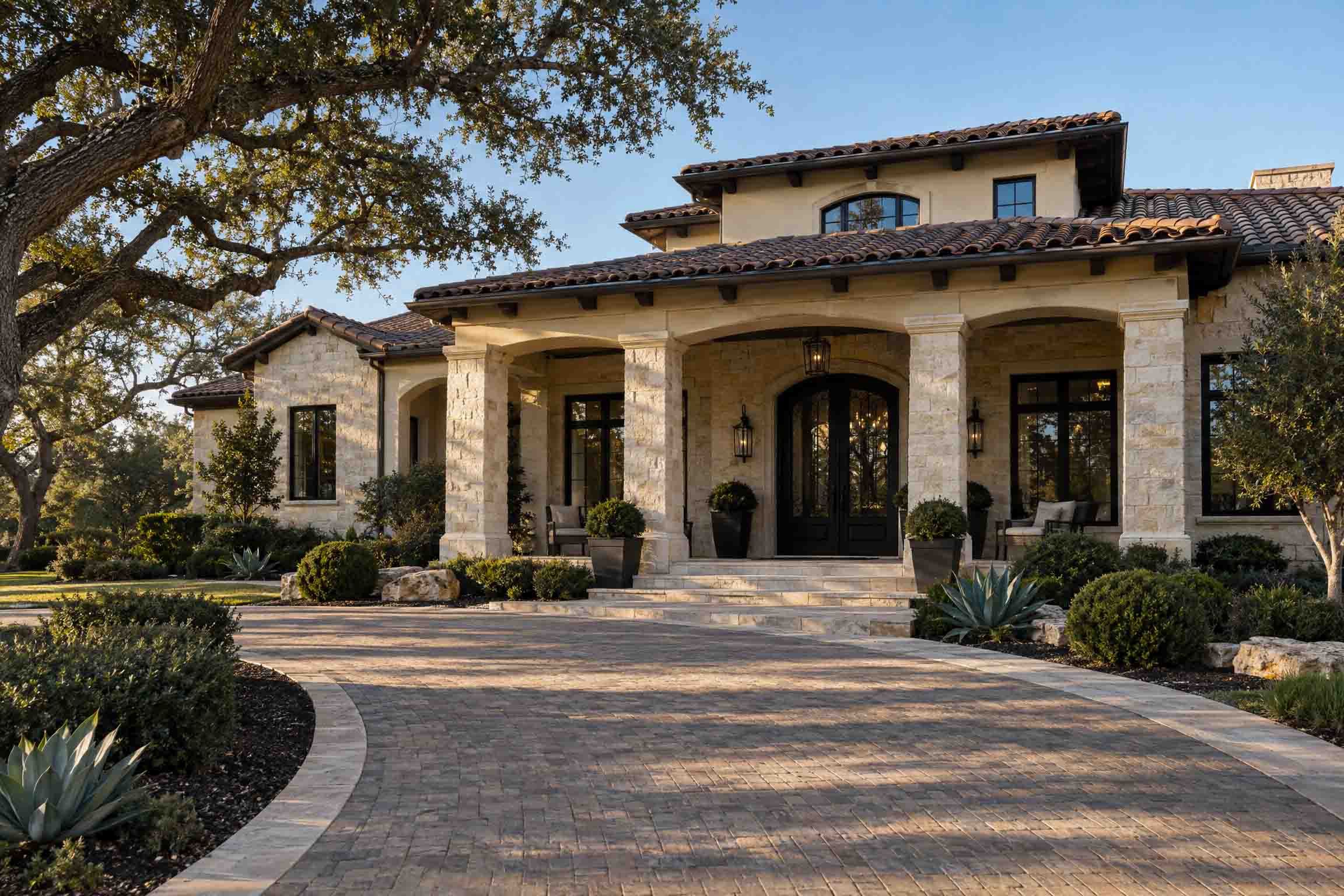 BEFORE: Undecorated San Antonio stone estate entrance before Bow & Bough Designs custom seasonal installation
