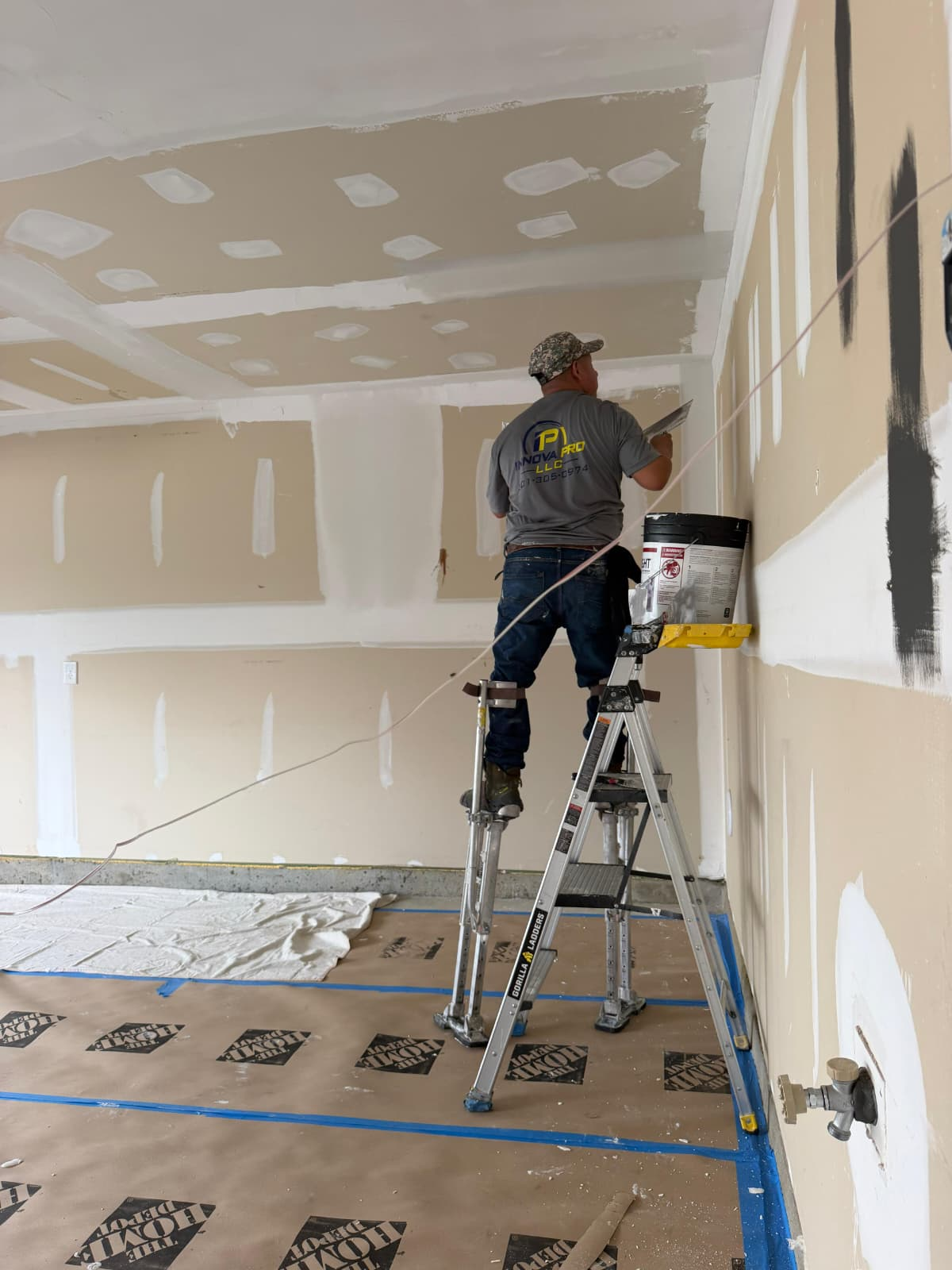 Drywall Skim-Coating on Stilts with Laser Alignment