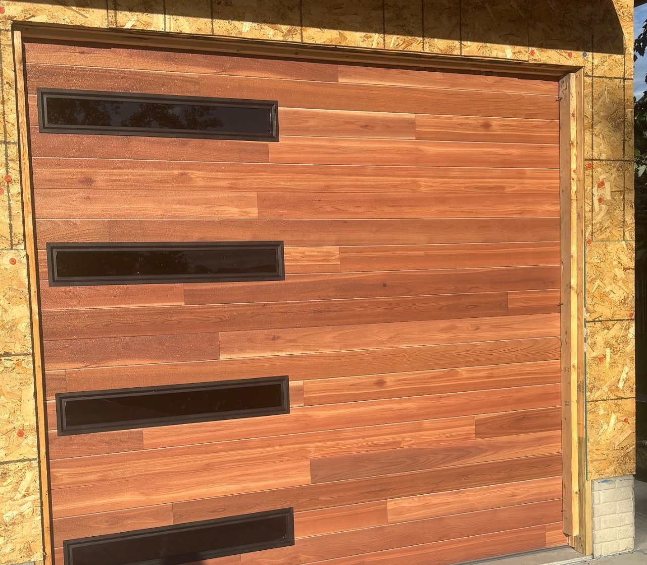 Wood grain single garage door with horizontal windows, Nelson Garage Solutions