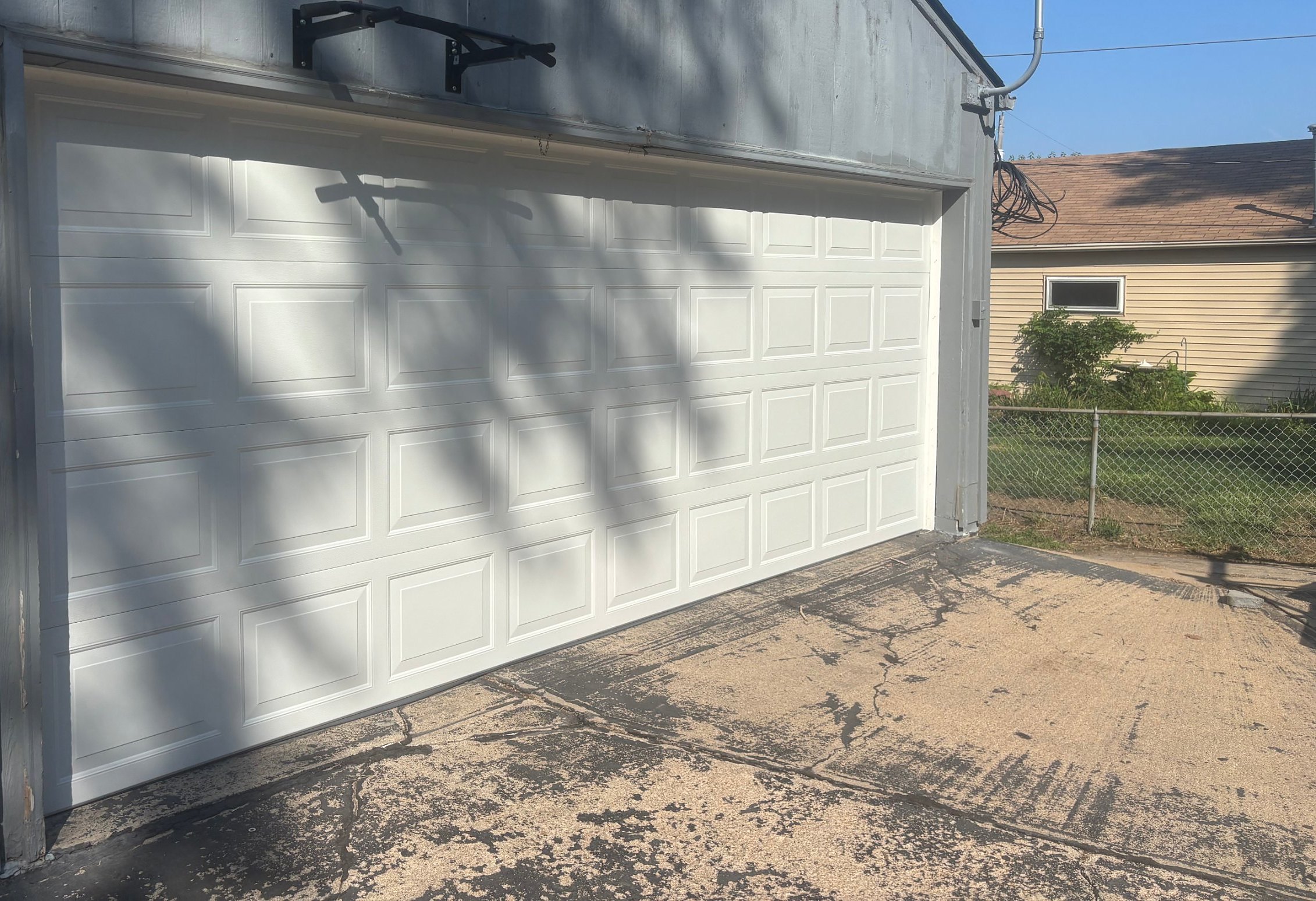 After: new white raised panel garage door installed by Nelson Garage Solutions