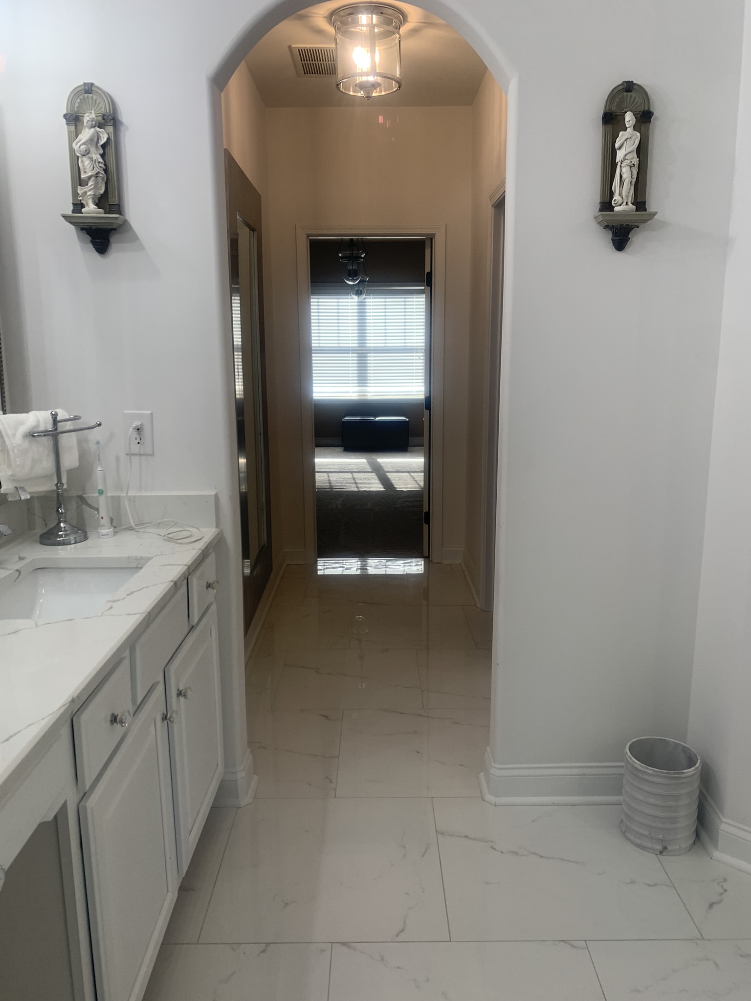 Gleaming marble-tile hallway and archways detailed by A & R Cleaning