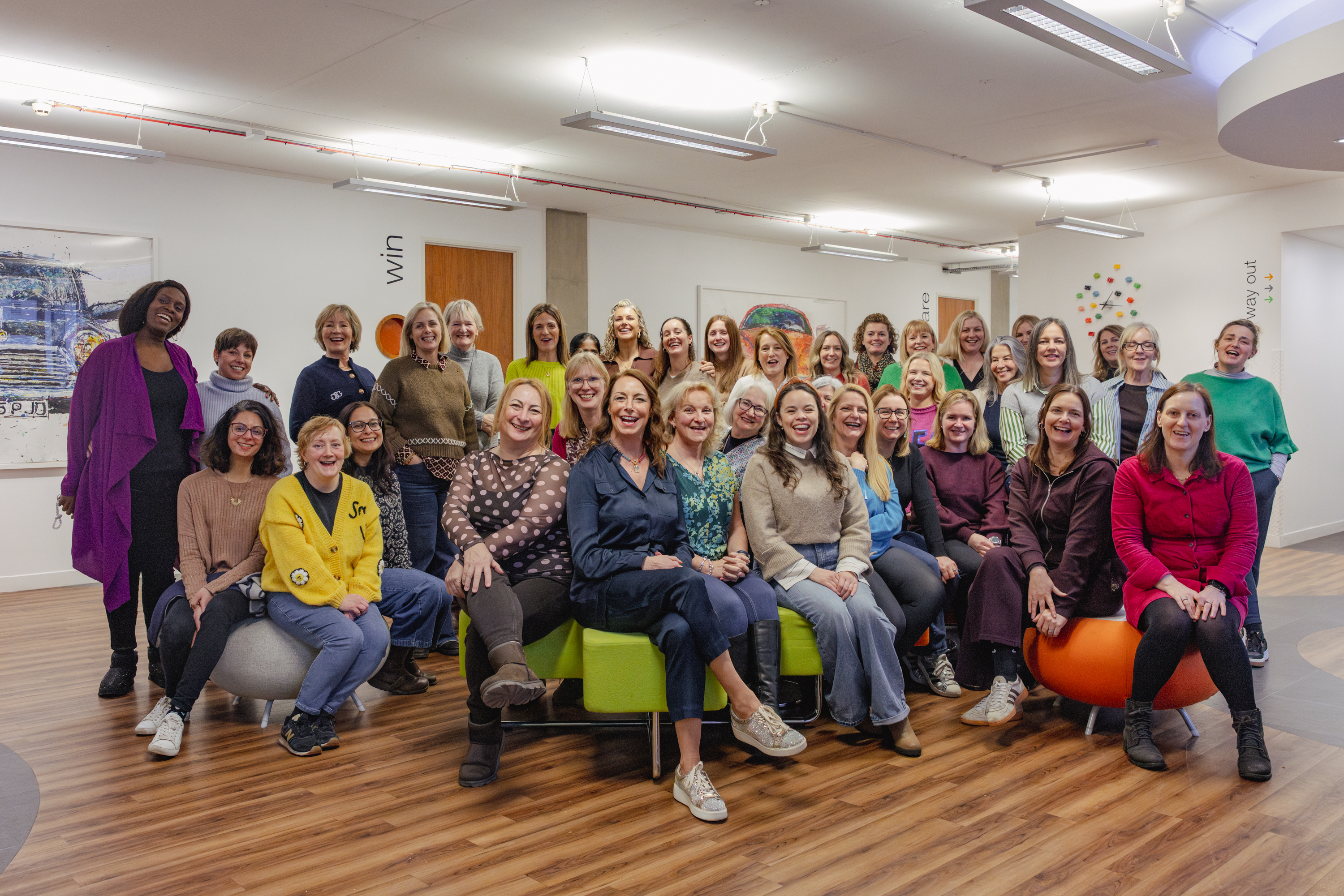 More than 50 women gathered together smiling and connecting at Life by Design