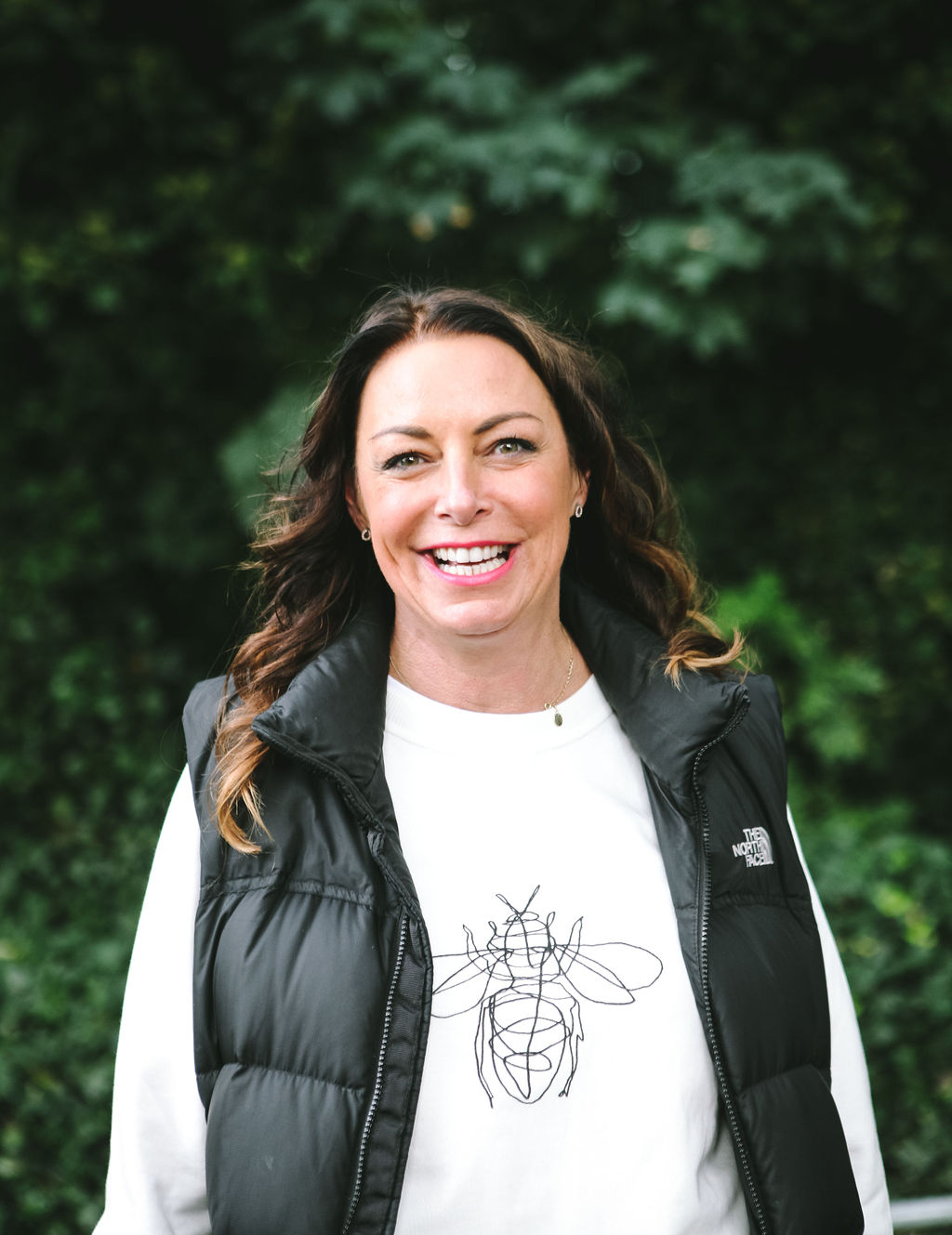 Amanda smiling outdoors in a North Face gilet
