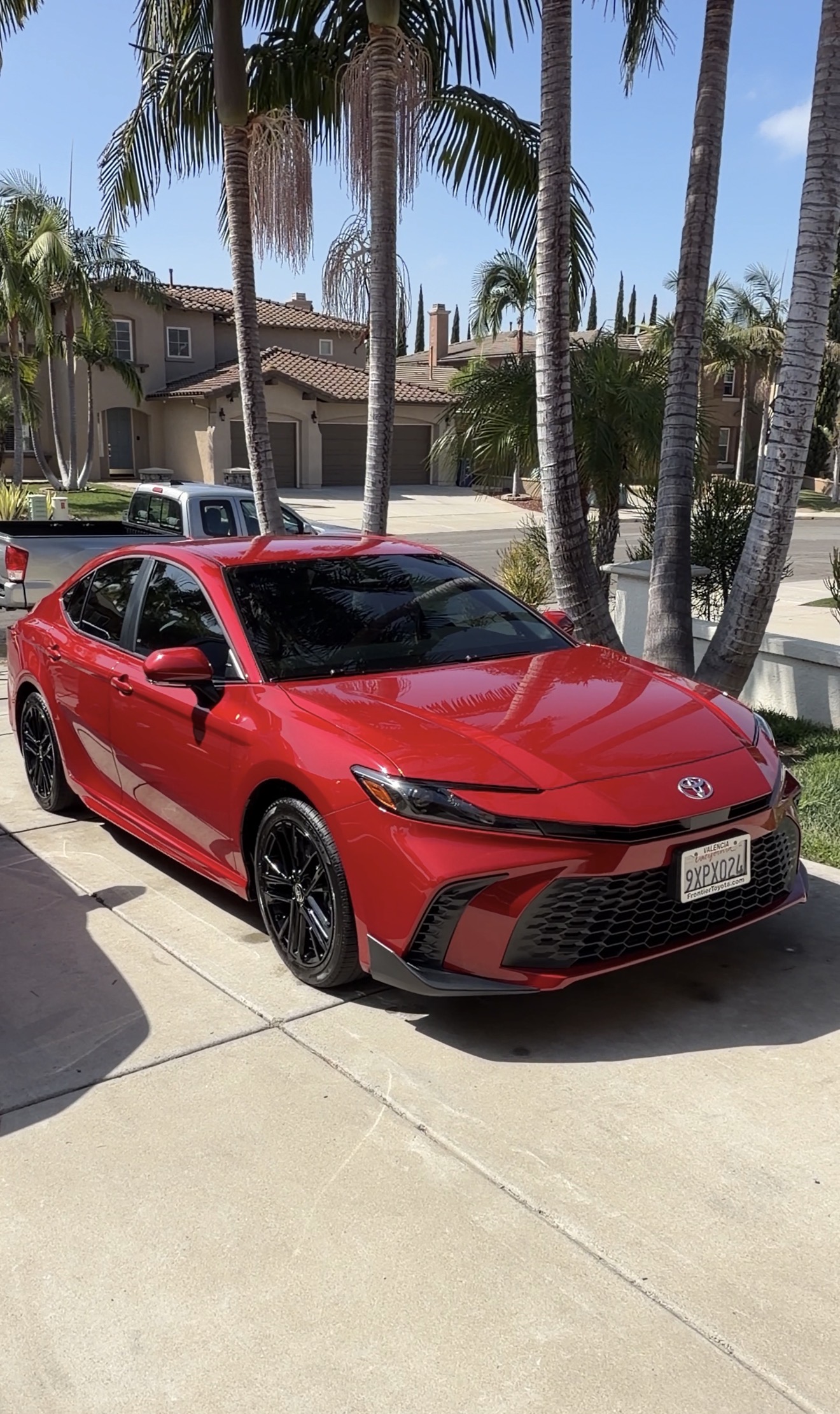 Gloss red Toyota Camry after complete exterior detail in the sun