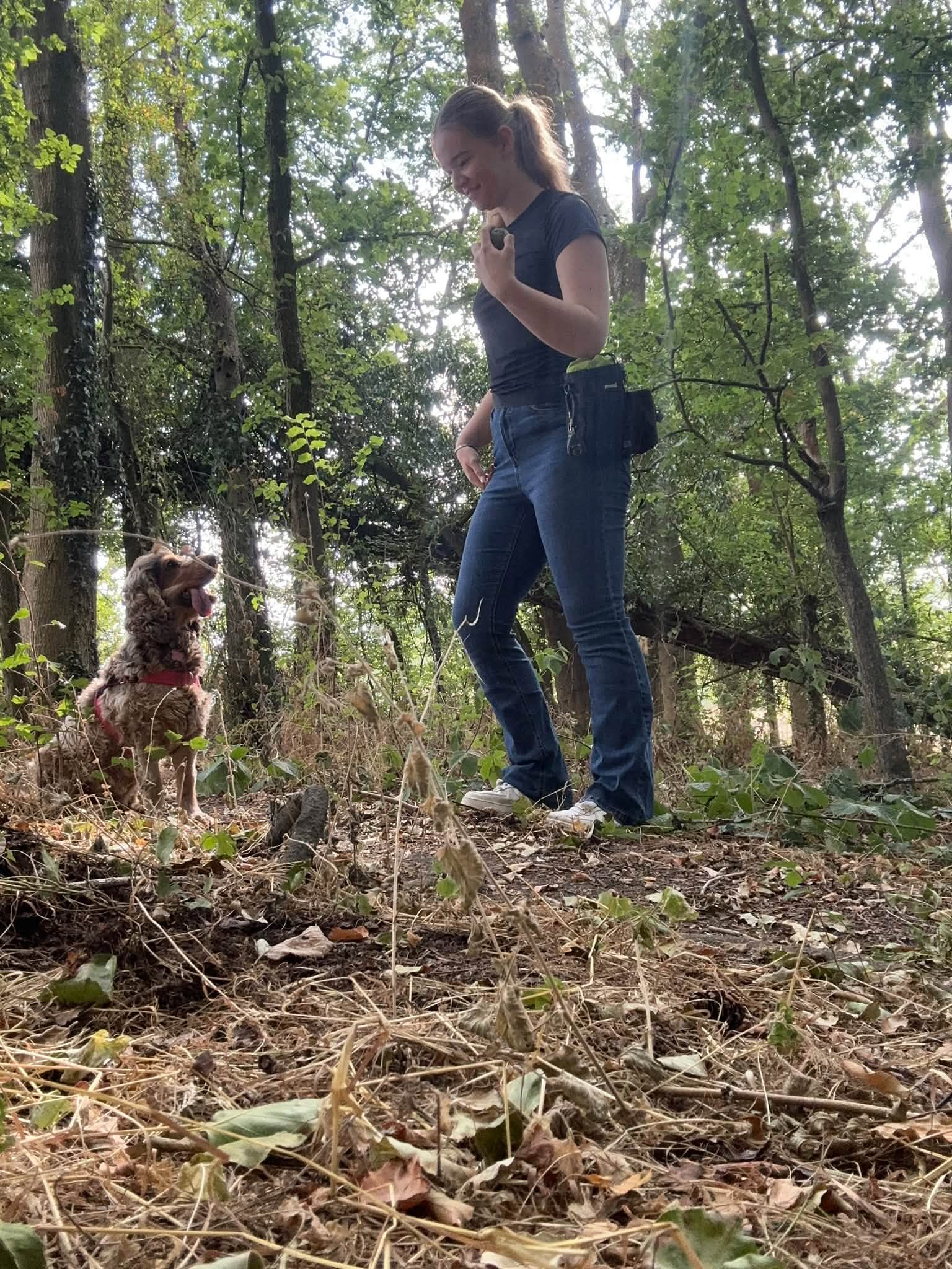 Eden walking through woodland with a dog