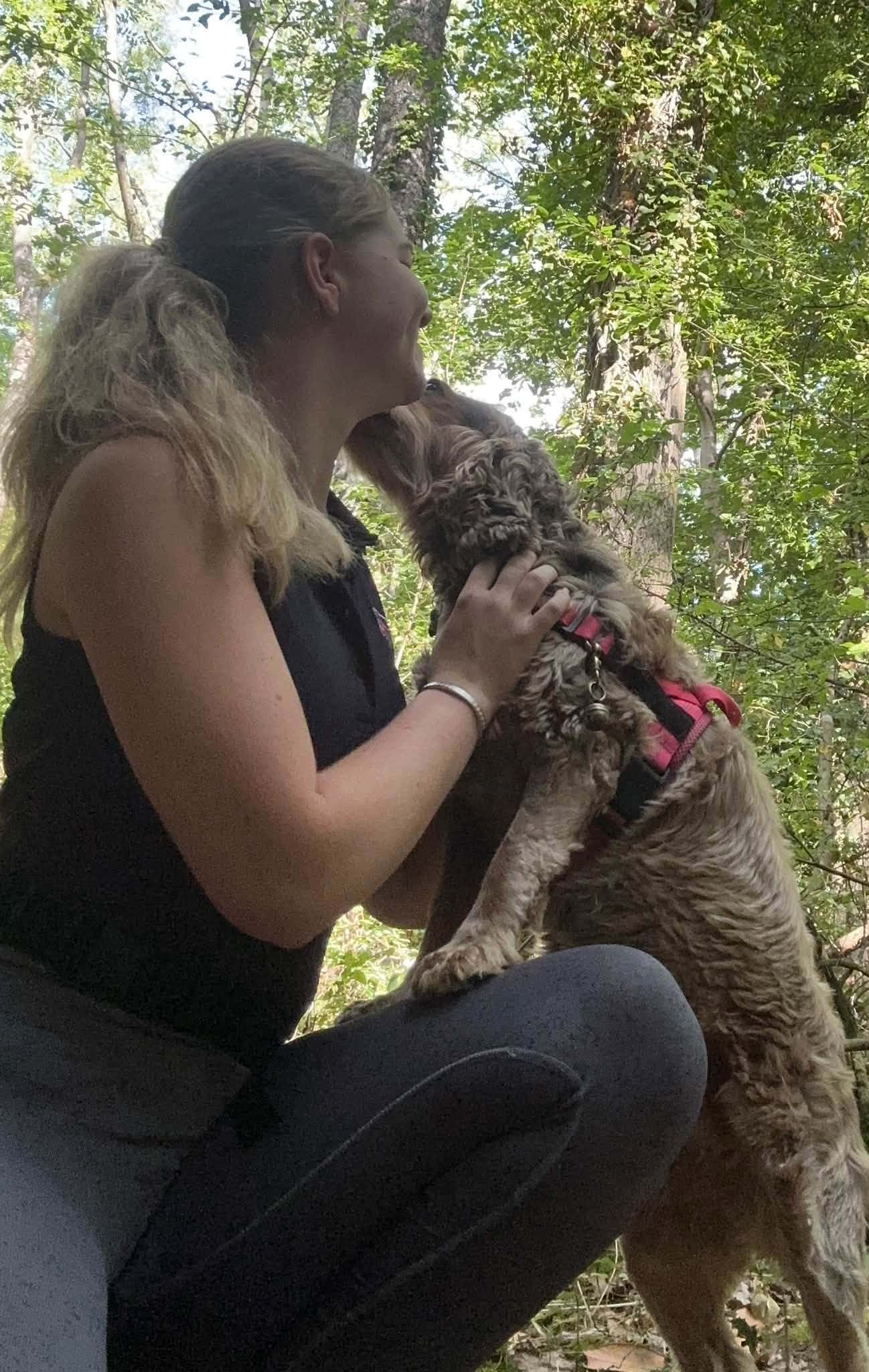 Eden cuddling and bonding with a gentle dog