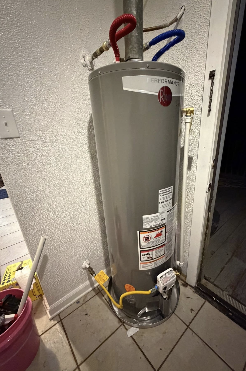 New Rheem gas water heater installed with safety pan, expansion lines and gas flex