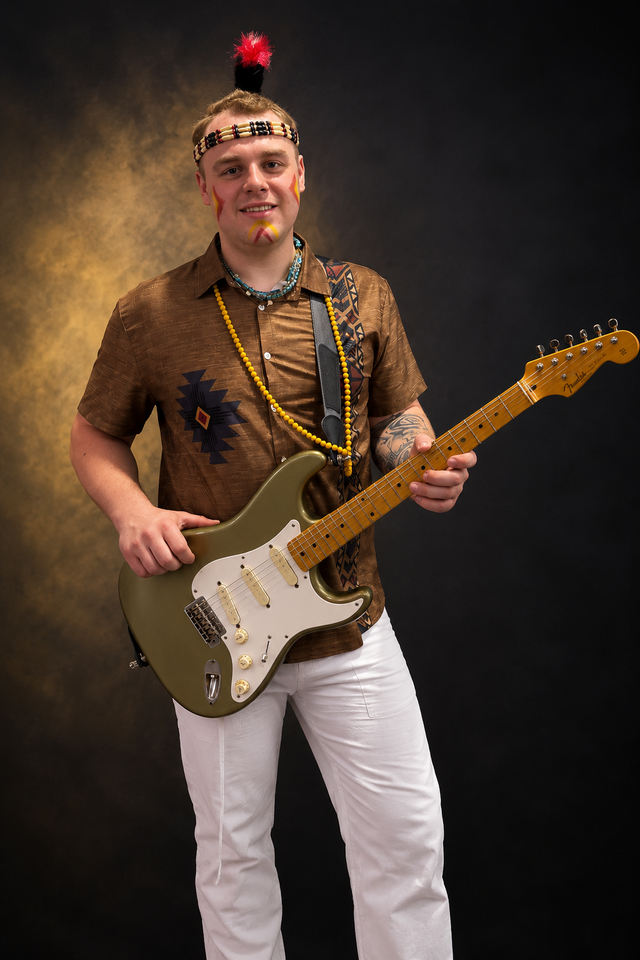 Lead guitarist performing with The New Indians Showband under stage lights