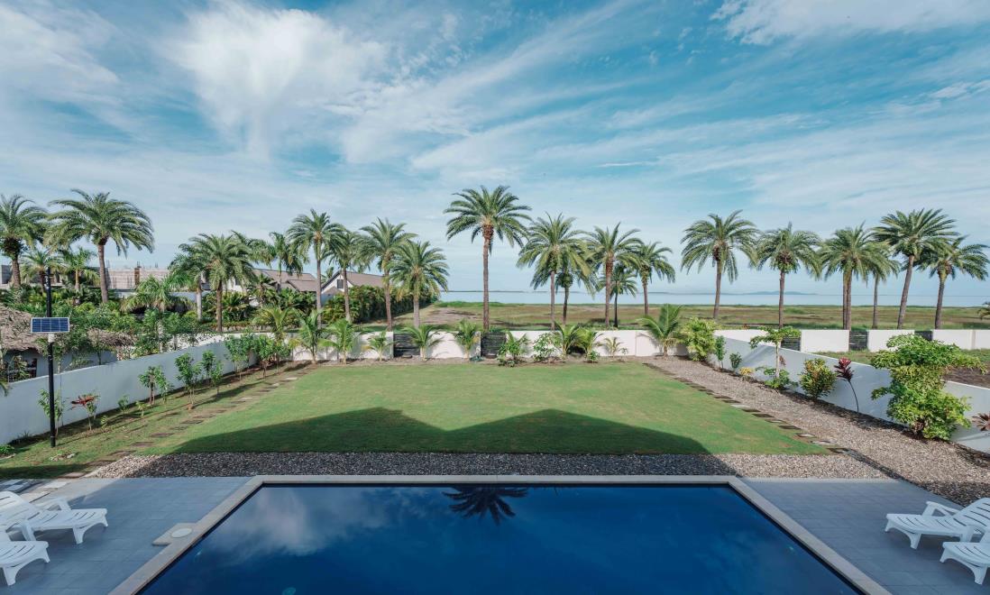 Villa 102's garden and pool looking out toward the sea