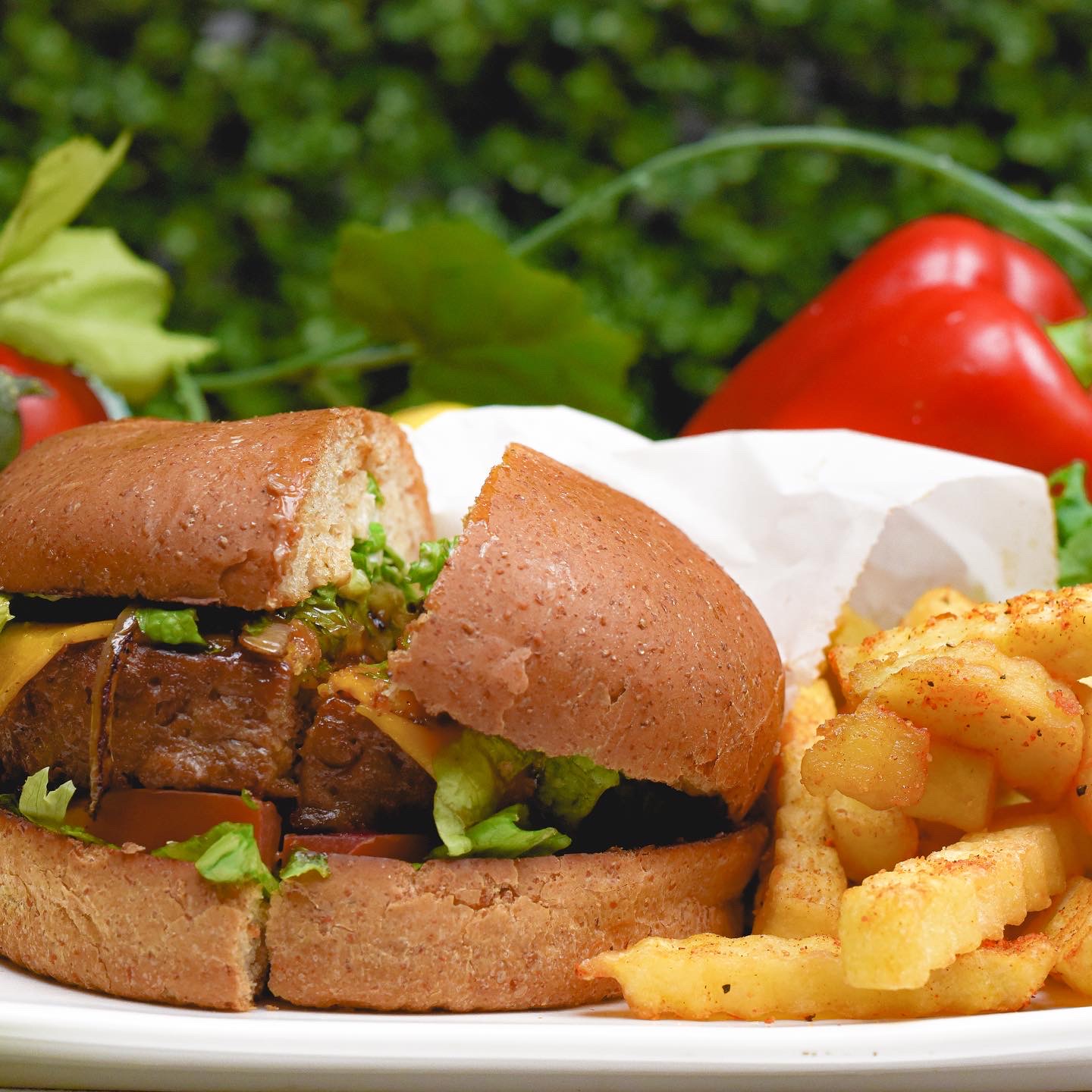Sunshine's famous vegan burger served with a side and full toppings at the Houston deli