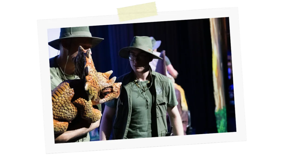 Rangers holding a baby Triceratops puppet during the live show