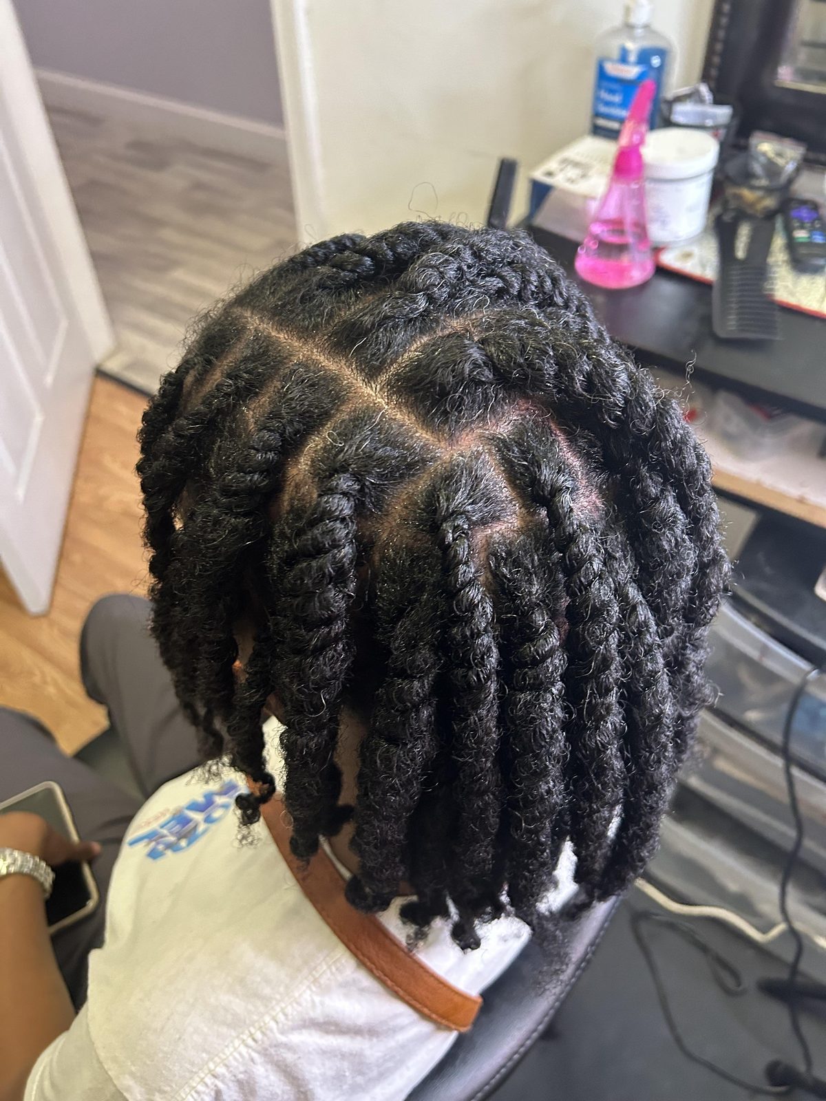 Clean center-parted thick two-strand rope loc twists with glossy finish by Jennifer J at LOC & Curl Xpress ATL Salon in Decatur, GA