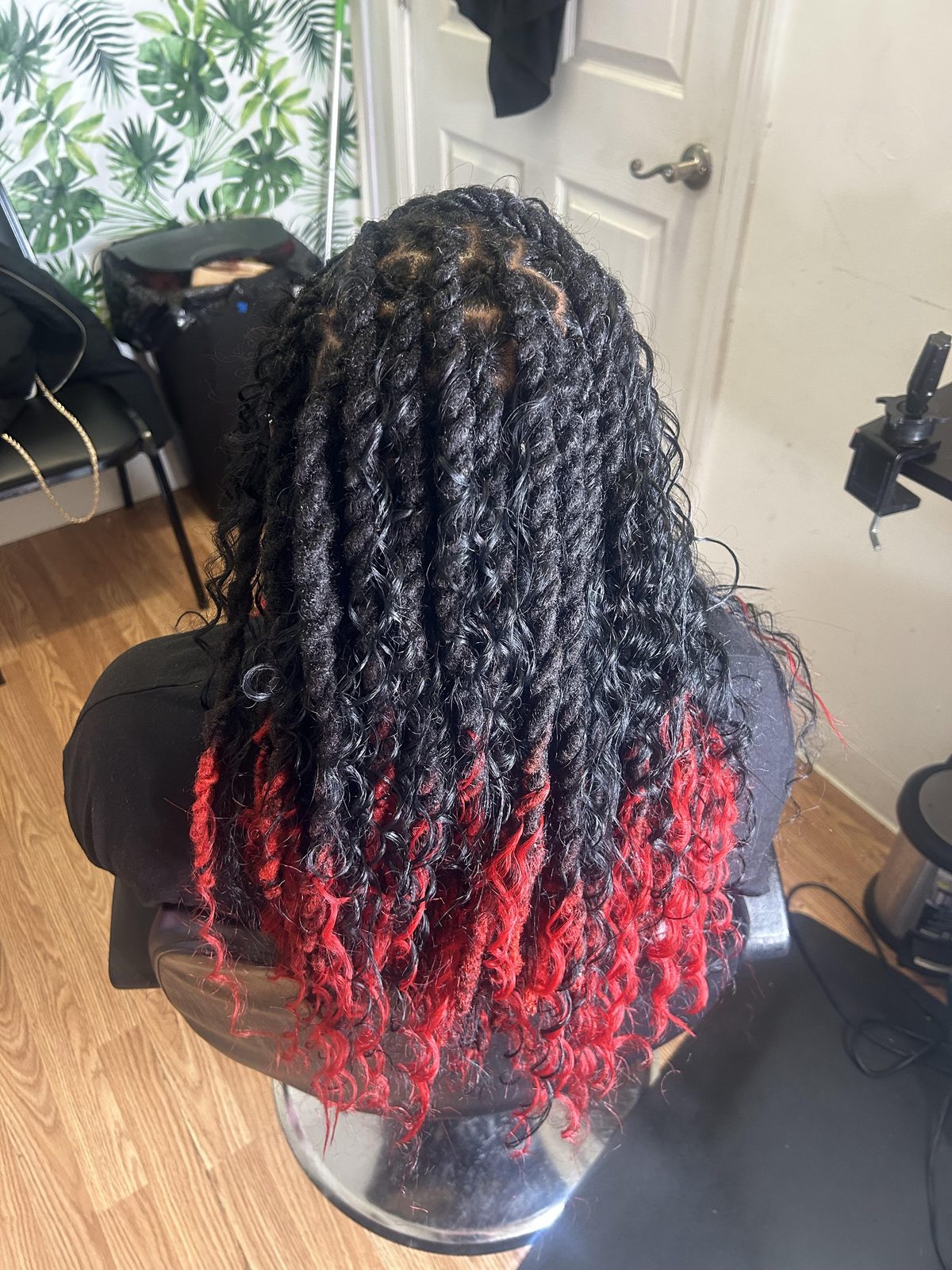 Two-strand loc twists with bright crimson red tips and loose curly ends by Jennifer J at LOC & Curl Xpress ATL Salon in Decatur, GA