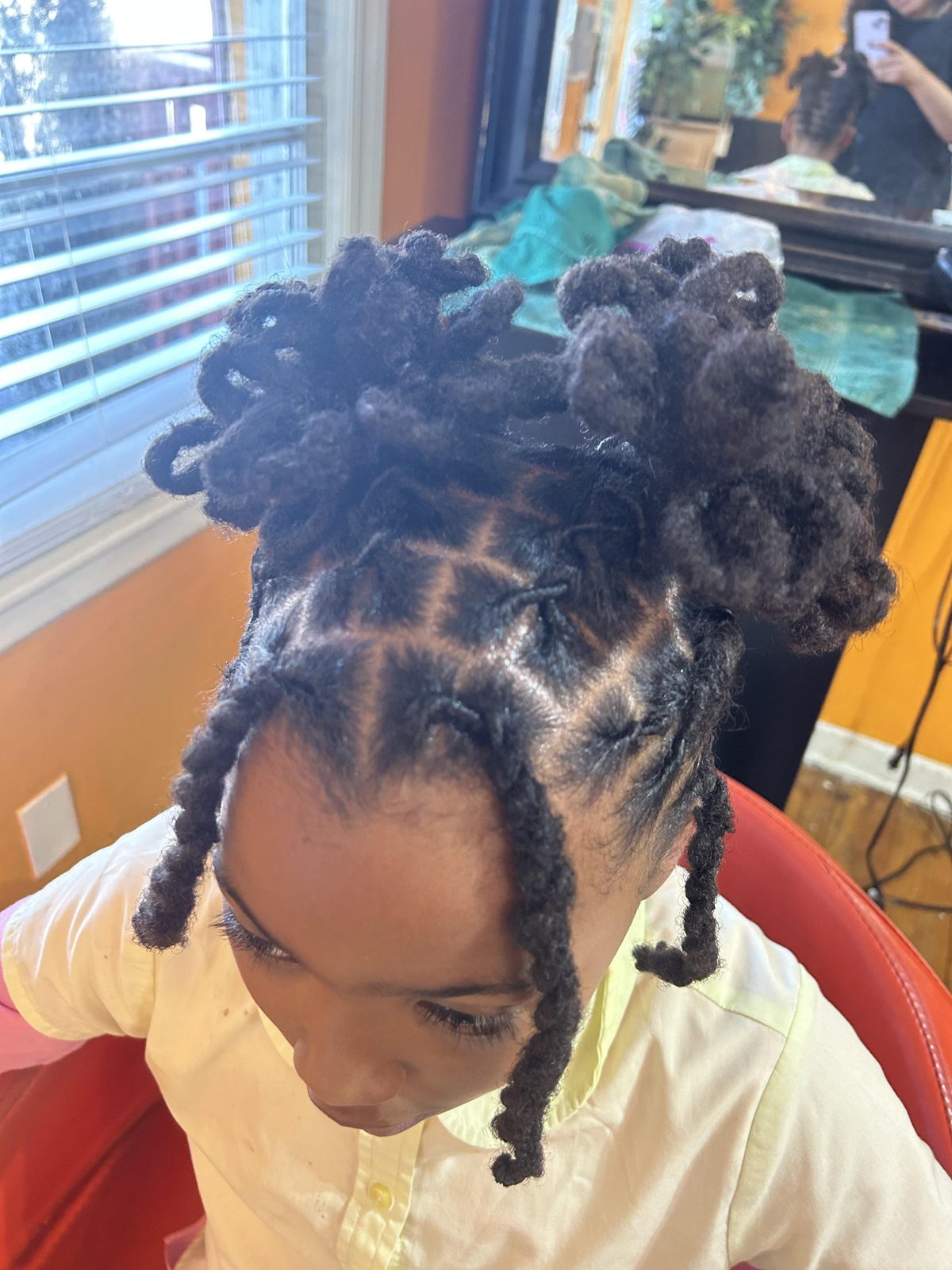 Creative young client loc pin-up buns with fresh parts and front face-framing locs by Jennifer J at LOC & Curl Xpress ATL Salon in Decatur, GA