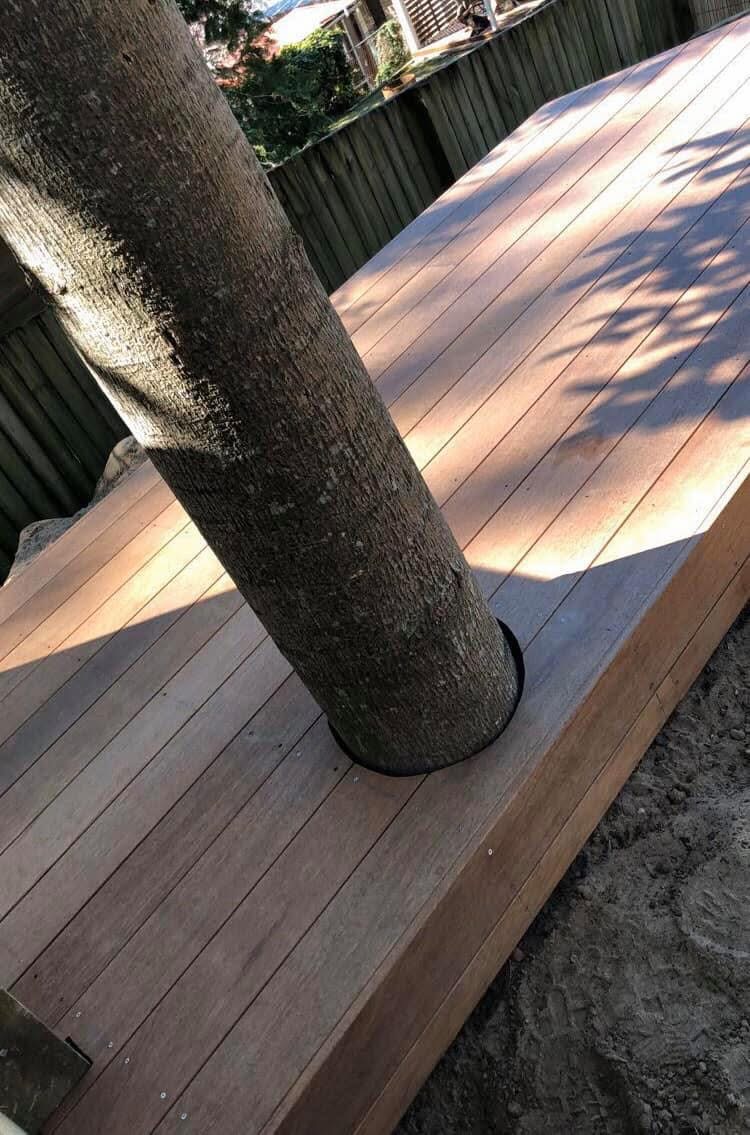Custom timber deck built neatly around an existing tree