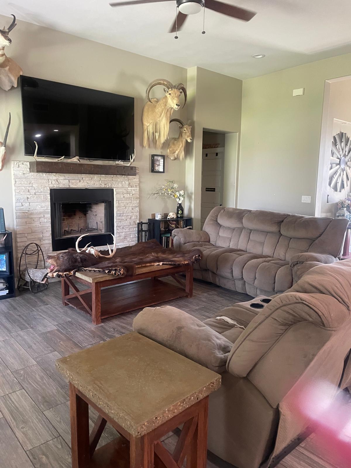 Immaculate living room and stone fireplace detailed by Adri's Cleaning Services in Hobbs NM