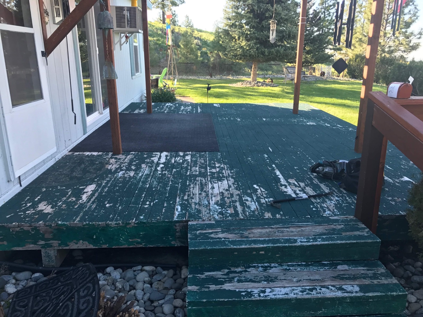 Severely peeling green deck paint before restoration by Rivercrest Home Services LLC in Wenatchee WA