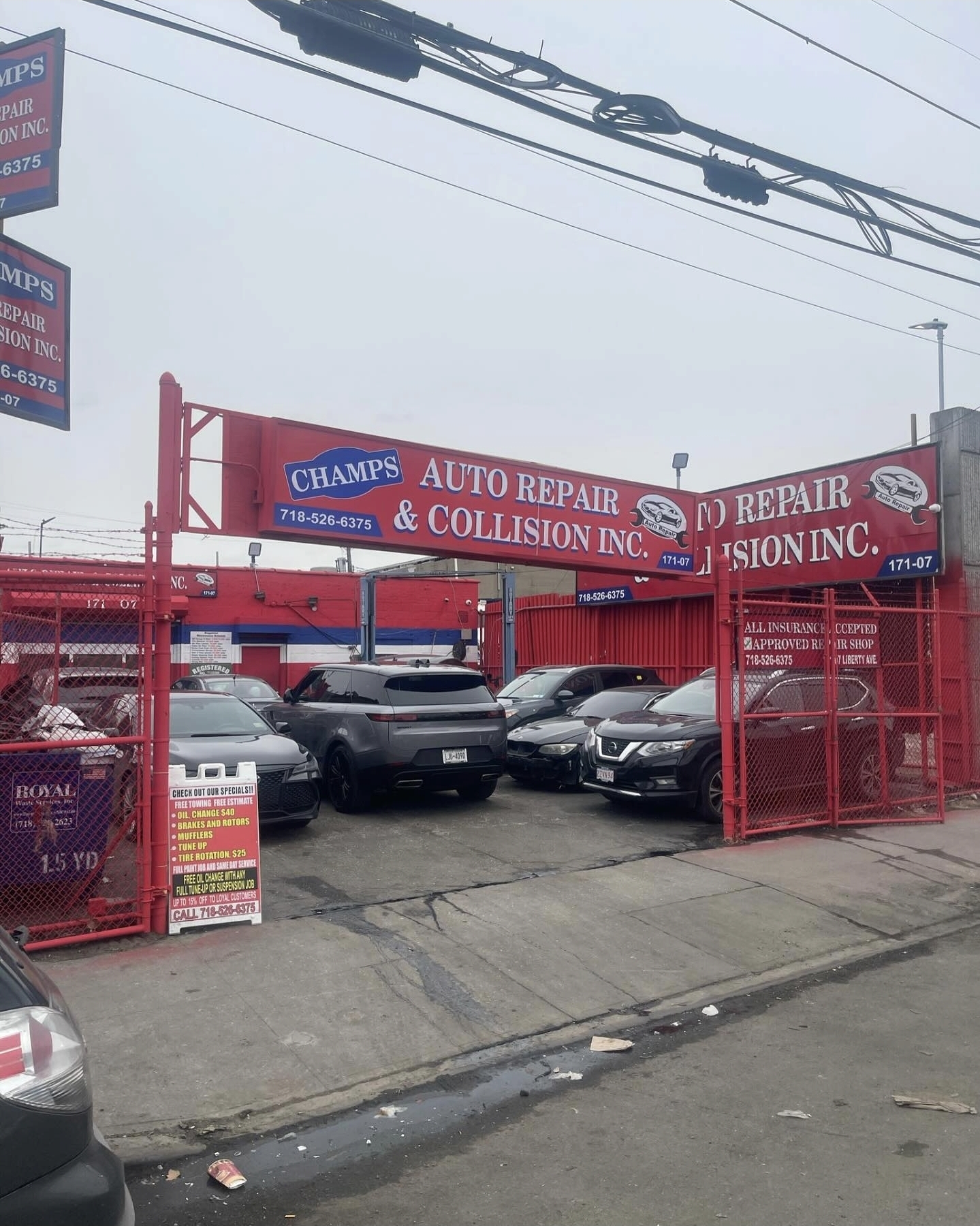 Champs Auto Repair & Collision Inc. front entrance and vehicle lot on Liberty Ave