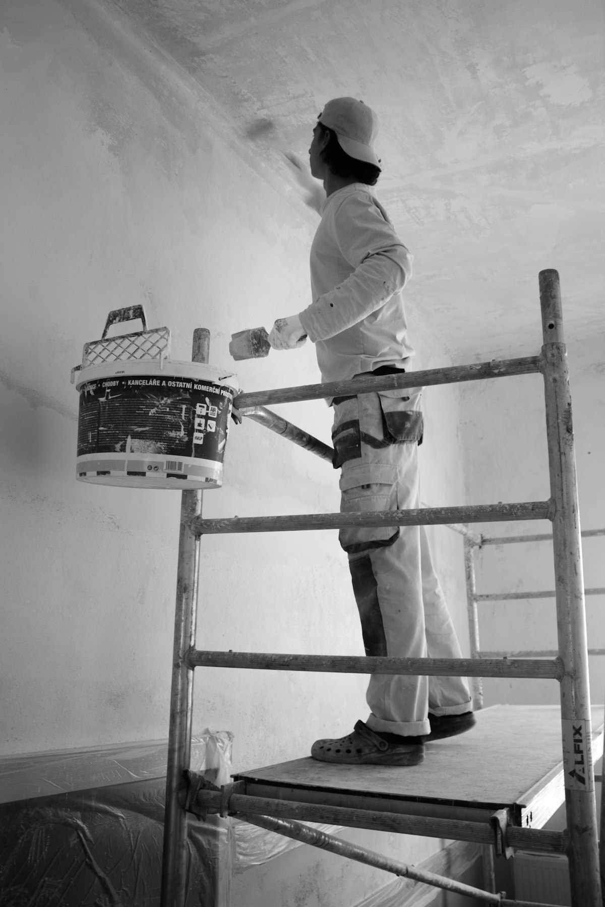Interior painter rolling fresh paint onto a residential wall in Tampa FL
