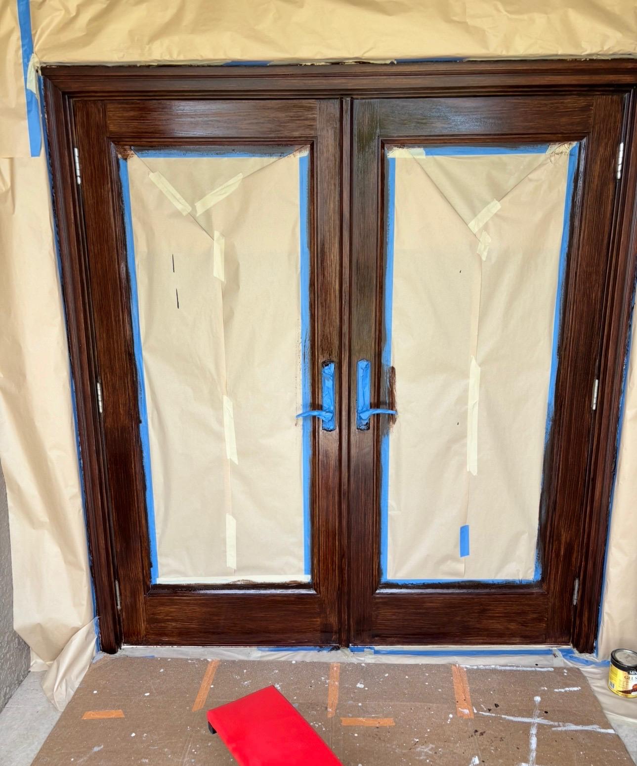 Double wood entry doors stained in deep mahogany finish with protective topcoat in Odessa FL