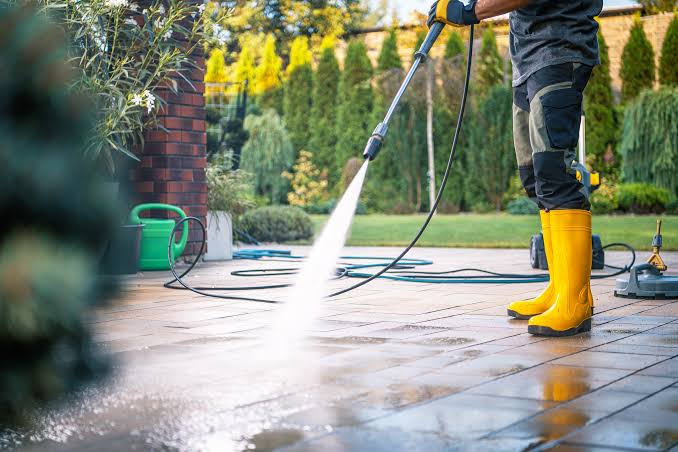 Pressure washing contractor preparing exterior power washing in Tampa FL