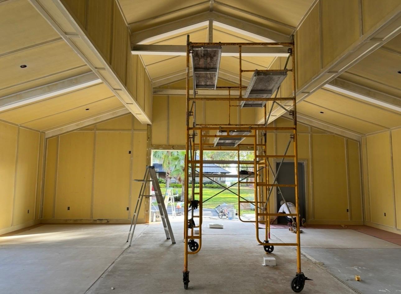Commercial and residential high-ceiling interior drywall priming, texturing, and scaffolding staging in Wesley Chapel FL