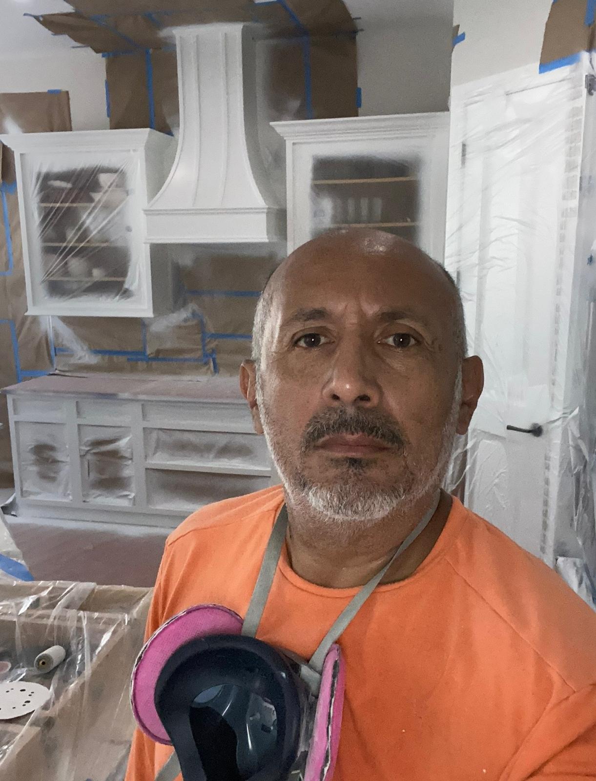 Ecuaconstruction Corp founder John Granda on-site with respirator during containment and kitchen cabinet spray finishing in Land O' Lakes FL