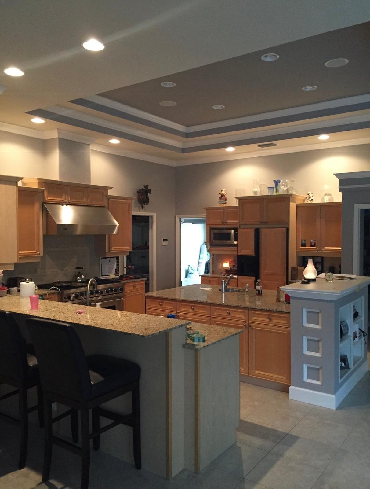 Honey oak kitchen cabinets and island prior to Ecuaconstruction Corp professional spray refinishing in Land O' Lakes FL