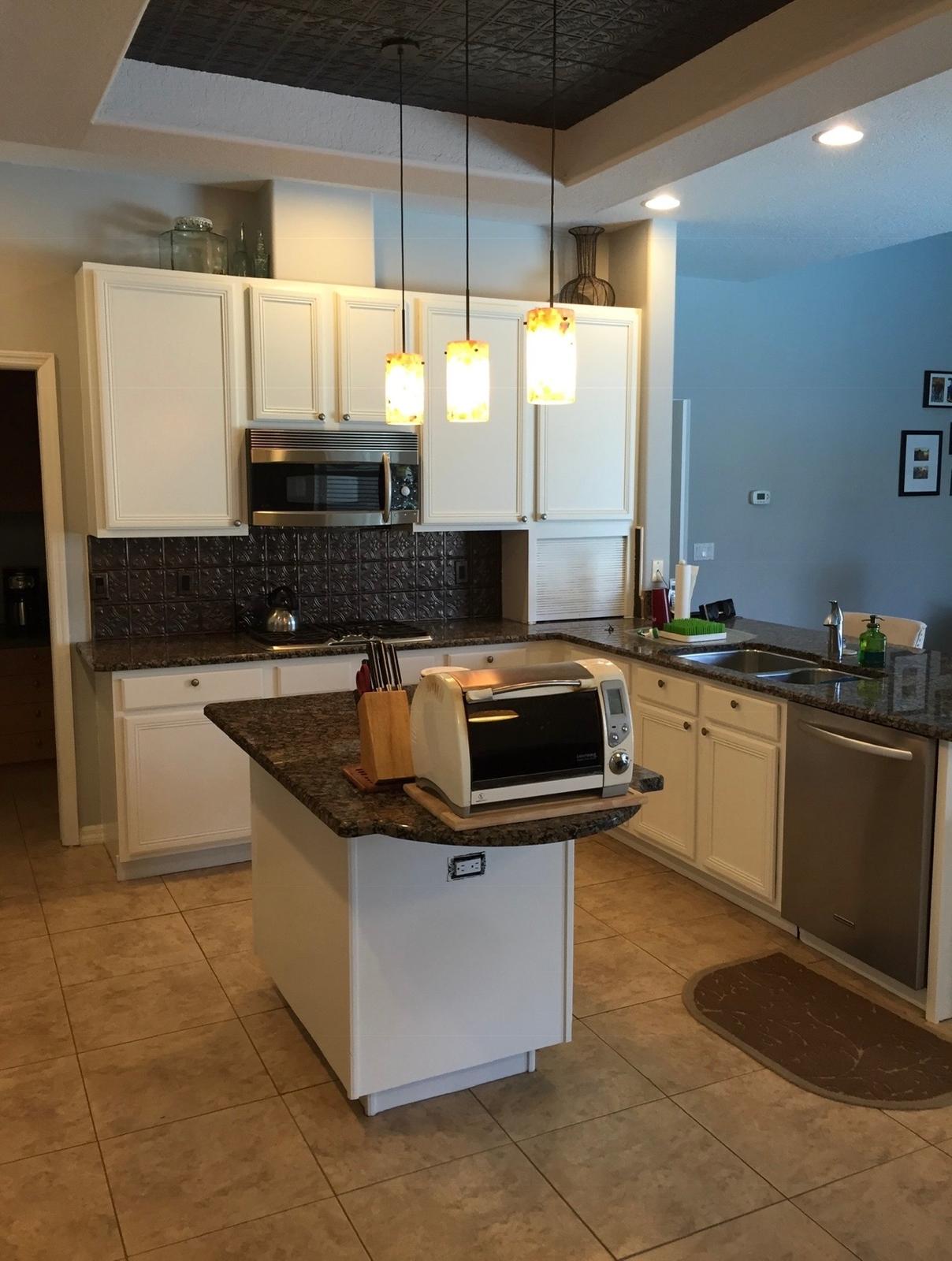 Pristine white kitchen cabinetry spray finish and island transformation in Tampa FL