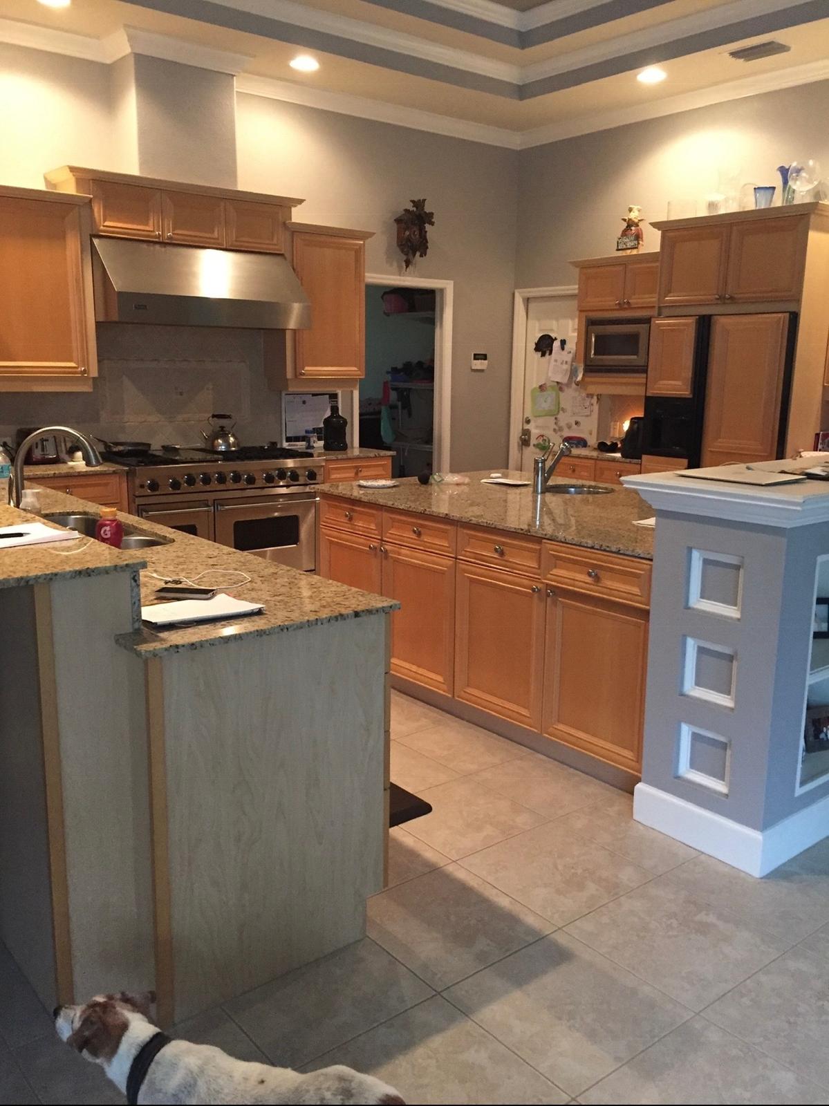Spacious kitchen with honey oak cabinets and dual tier island prior to cabinet spray refinishing in Land O' Lakes FL