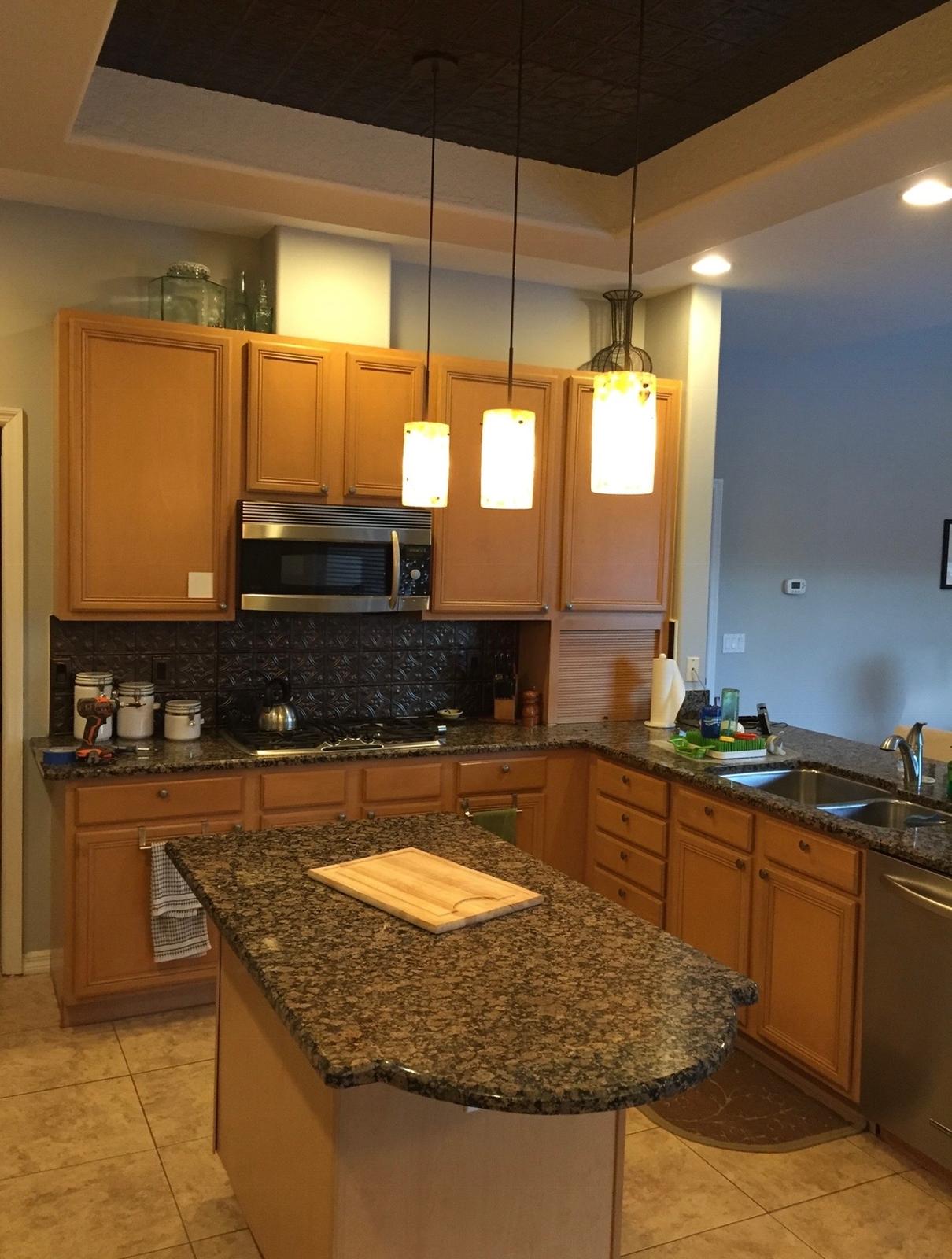 Kitchen oak cabinetry, granite island and custom tray ceiling accent prior to refinishing in Odessa FL