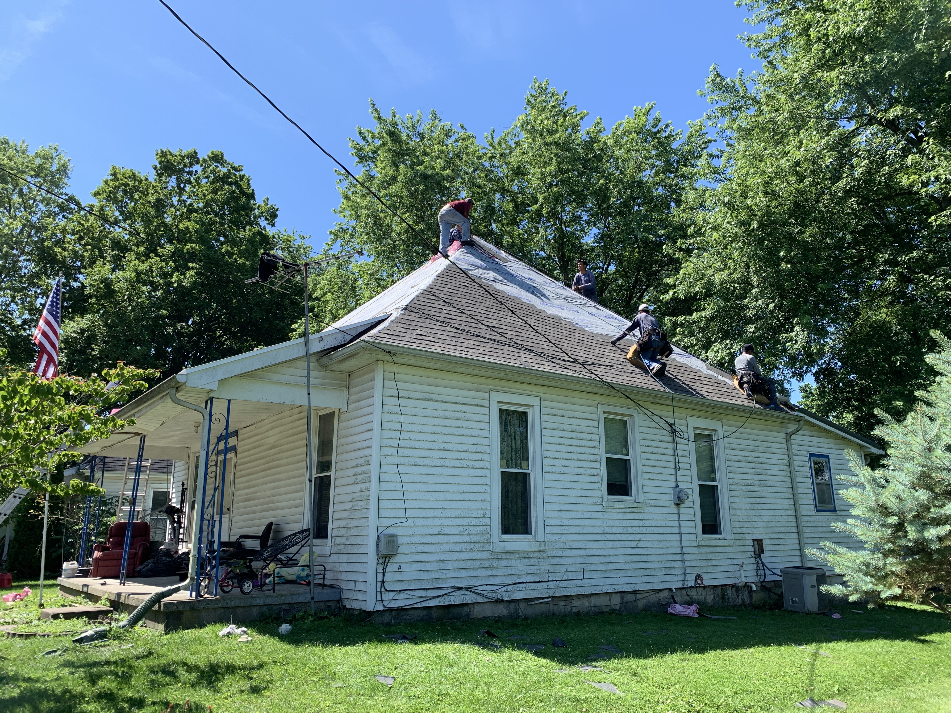 Residential asphalt shingle roof installation in progress on a home