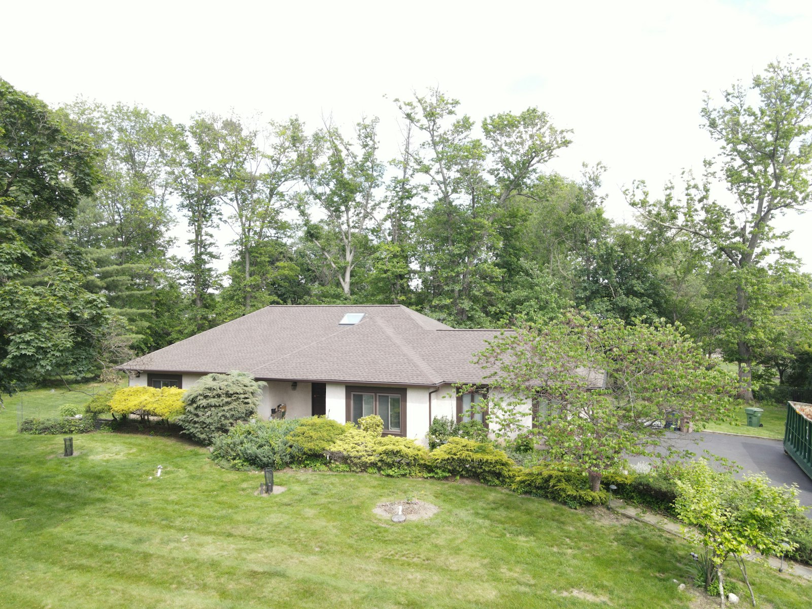 Completed residential asphalt shingle roof replacement on a suburban home