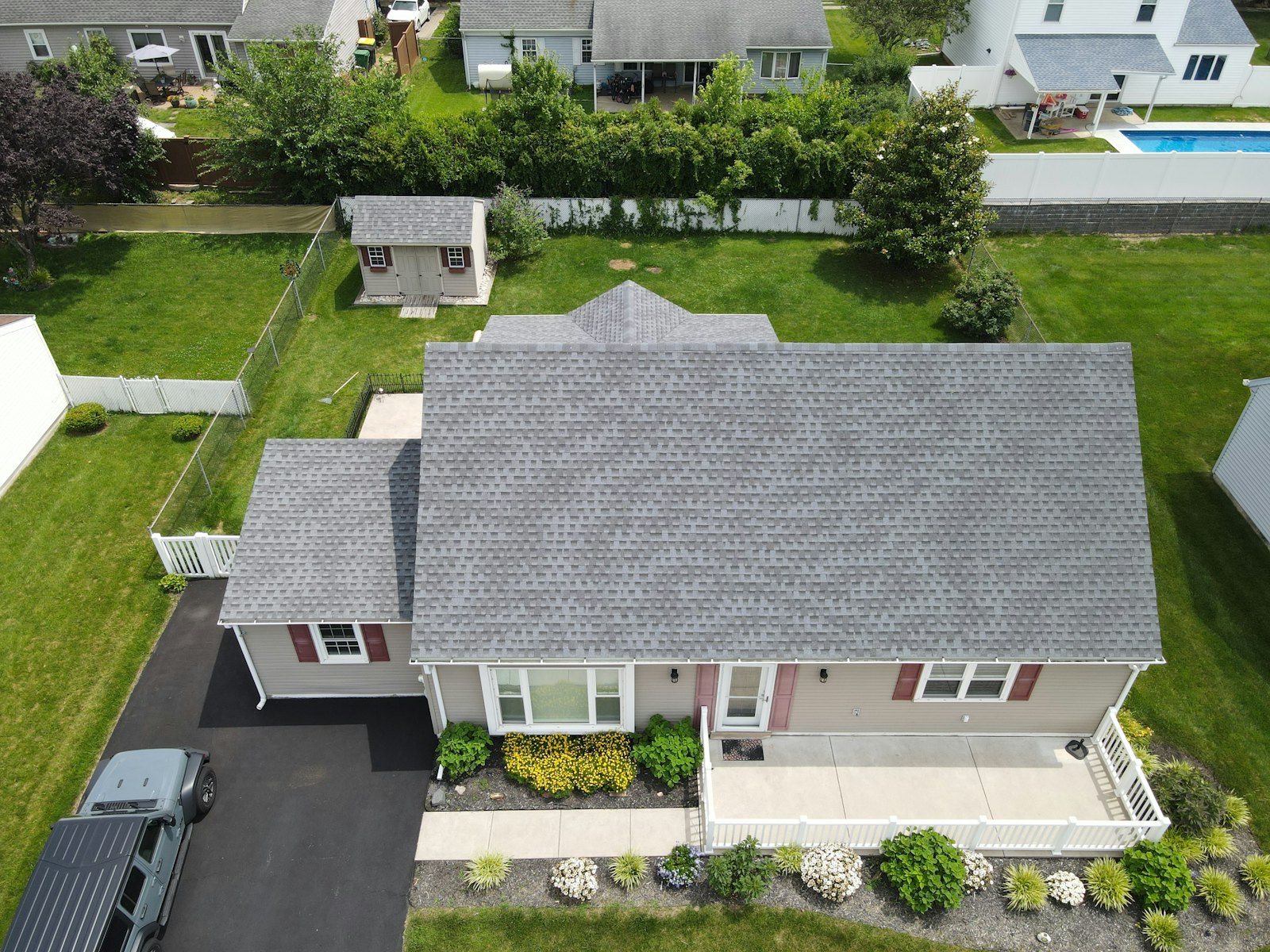 Completed residential asphalt shingle roof replacement on a suburban home