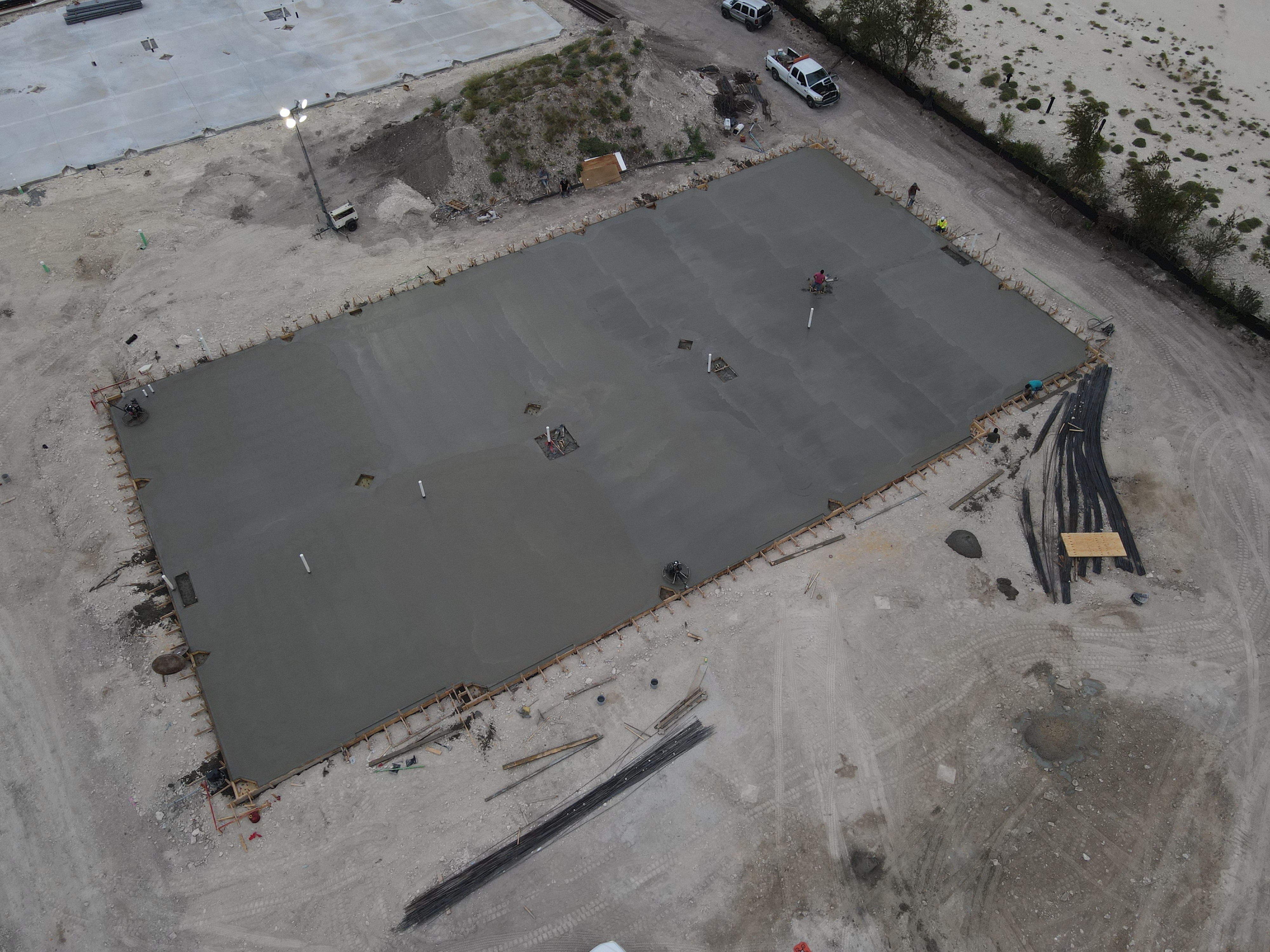 Reinforced commercial concrete warehouse slab with rebar grid and high-volume pump-truck pour by JIC Concrete in Melissa TX