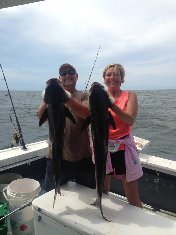 Couple holding two cobia caught on a trolling charter in the Gulf of Mexico near Biloxi
