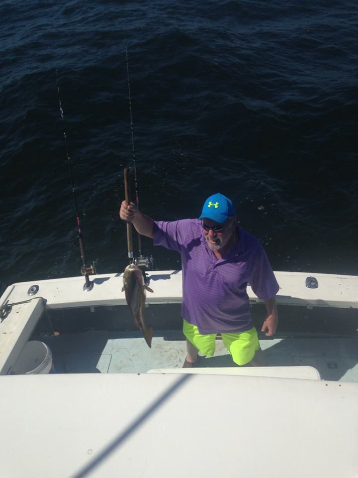 Angler holding a fish aboard the Shearwater offshore of Biloxi