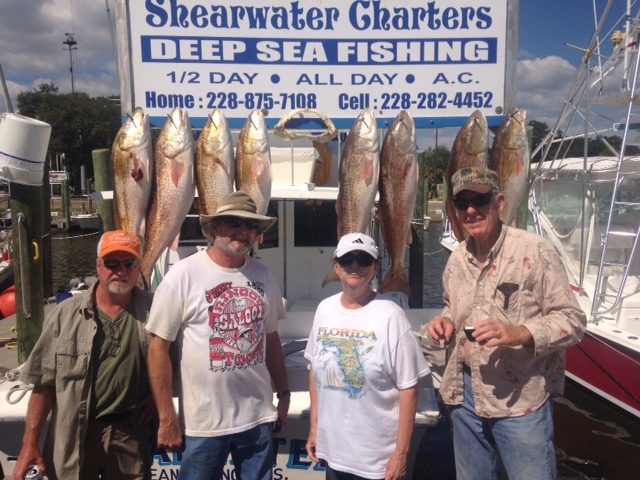 Group with a limit of redfish at Biloxi Small Craft Harbor after a 6-hour fishing trip