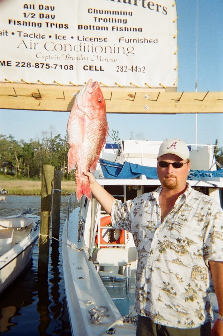 Vintage photo of a red snapper at the original Shearwater Charters sign listing trolling, bottom fishing and air conditioning