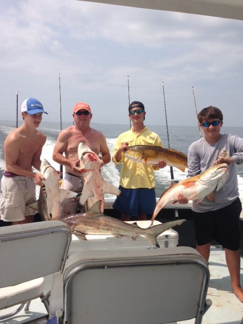 Group of young anglers with sharks and redfish aboard the Shearwater offshore of Biloxi