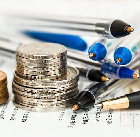 Coins and pens on loan paperwork