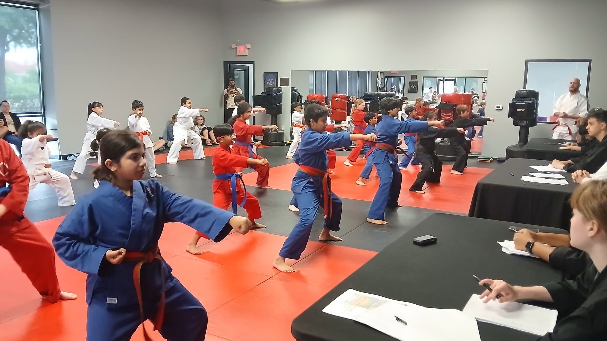 Action Karate students training together during martial arts class in the dojo